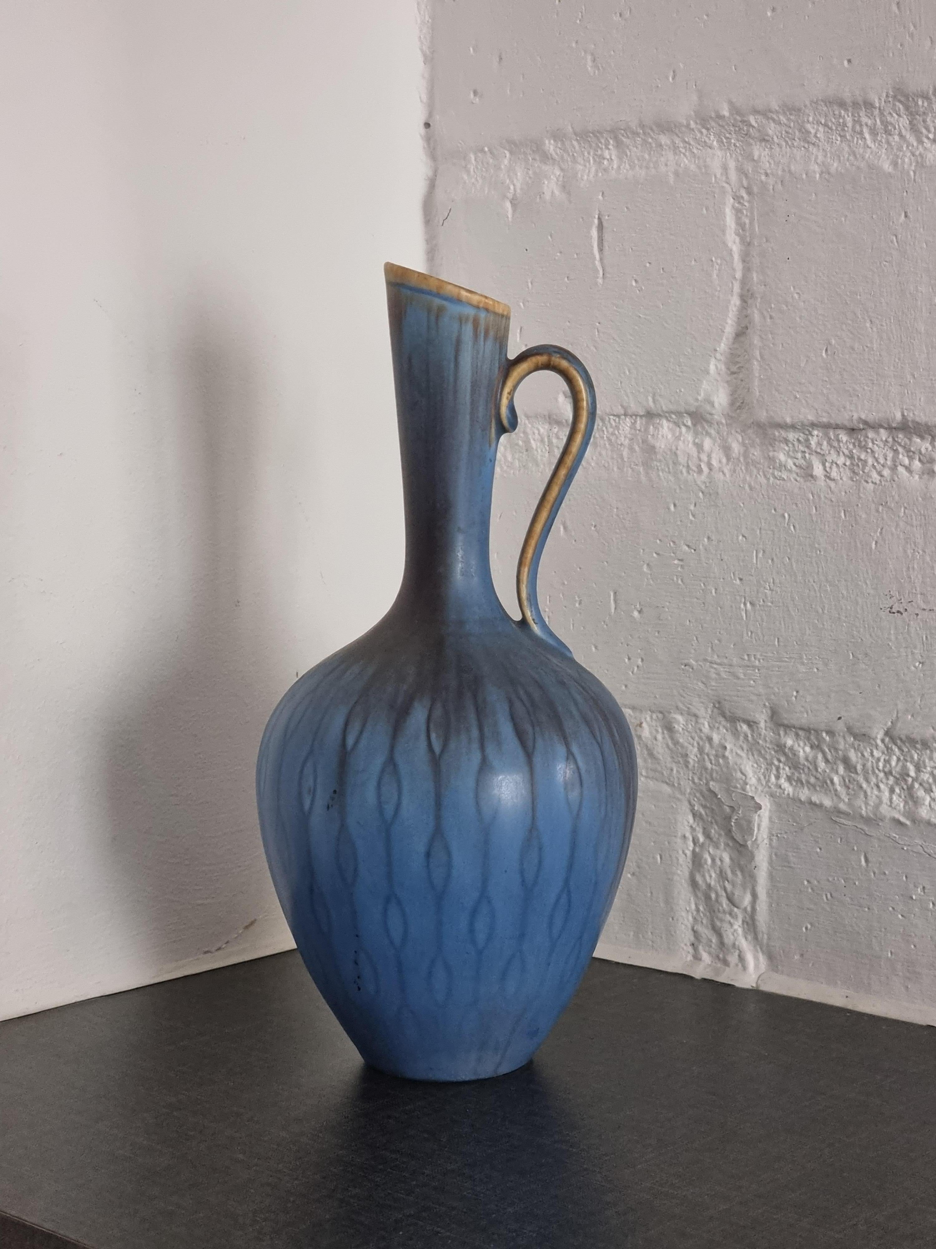 Ceramic carafe / vase with blue glaze and rare pattern by Gunnar Nylund for Rörstrand Sweden. Scandinavian Modern, mid-1900s. 

Signed. In good condition. Beautiful decorative shape and color, a true masterpiece by artist/designer Gunnar Nylund