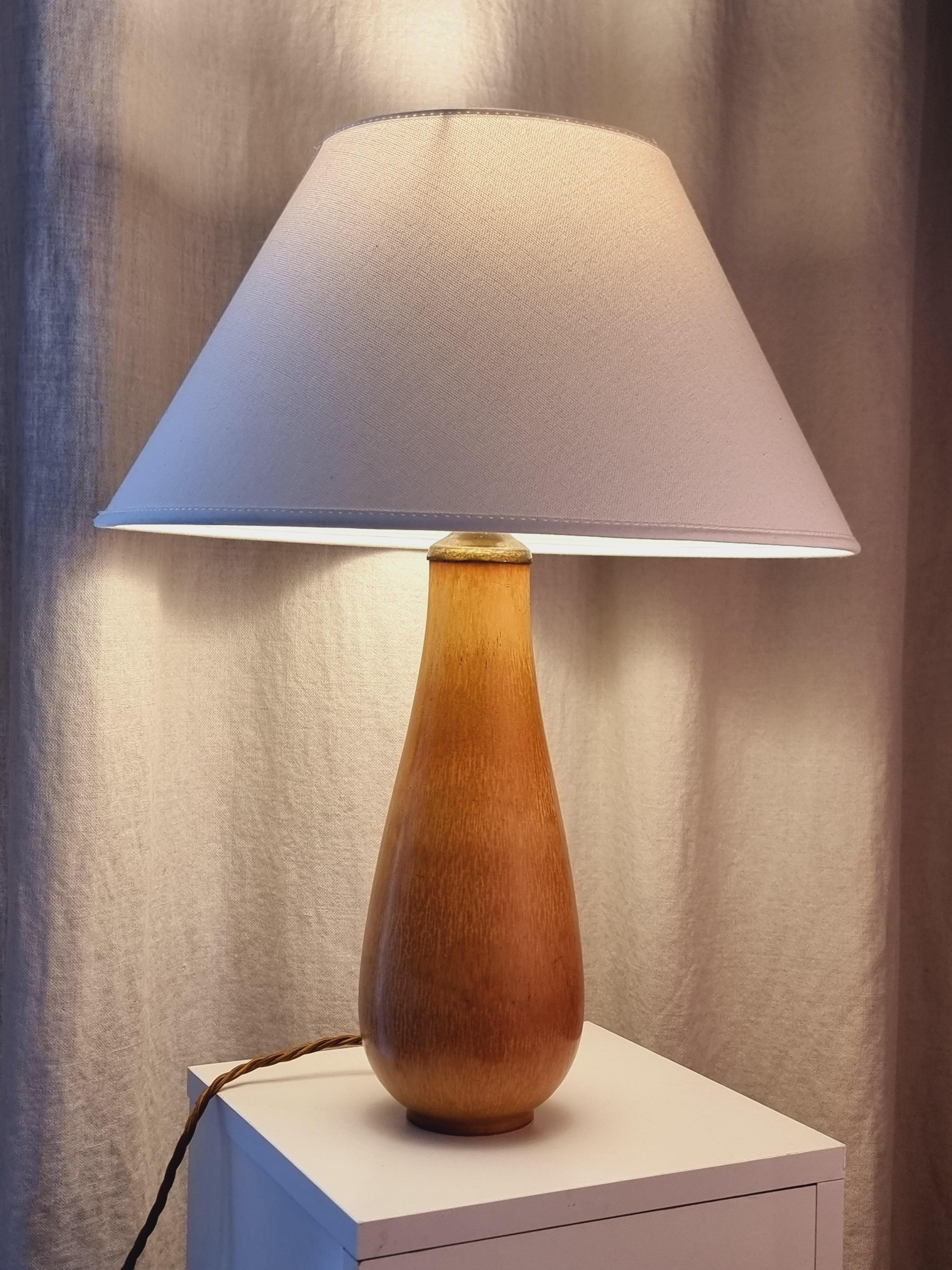 Ein schönes Beispiel für Gunnar Nylunds Kunstfertigkeit, eine Tischlampe aus Keramik mit brauner Hasenfellglasur. 

Gekennzeichnet mit Rörstrand und G. Nylund im Boden. In gutem Zustand, neue Verkabelung nach schwedischem Standard.

Über den