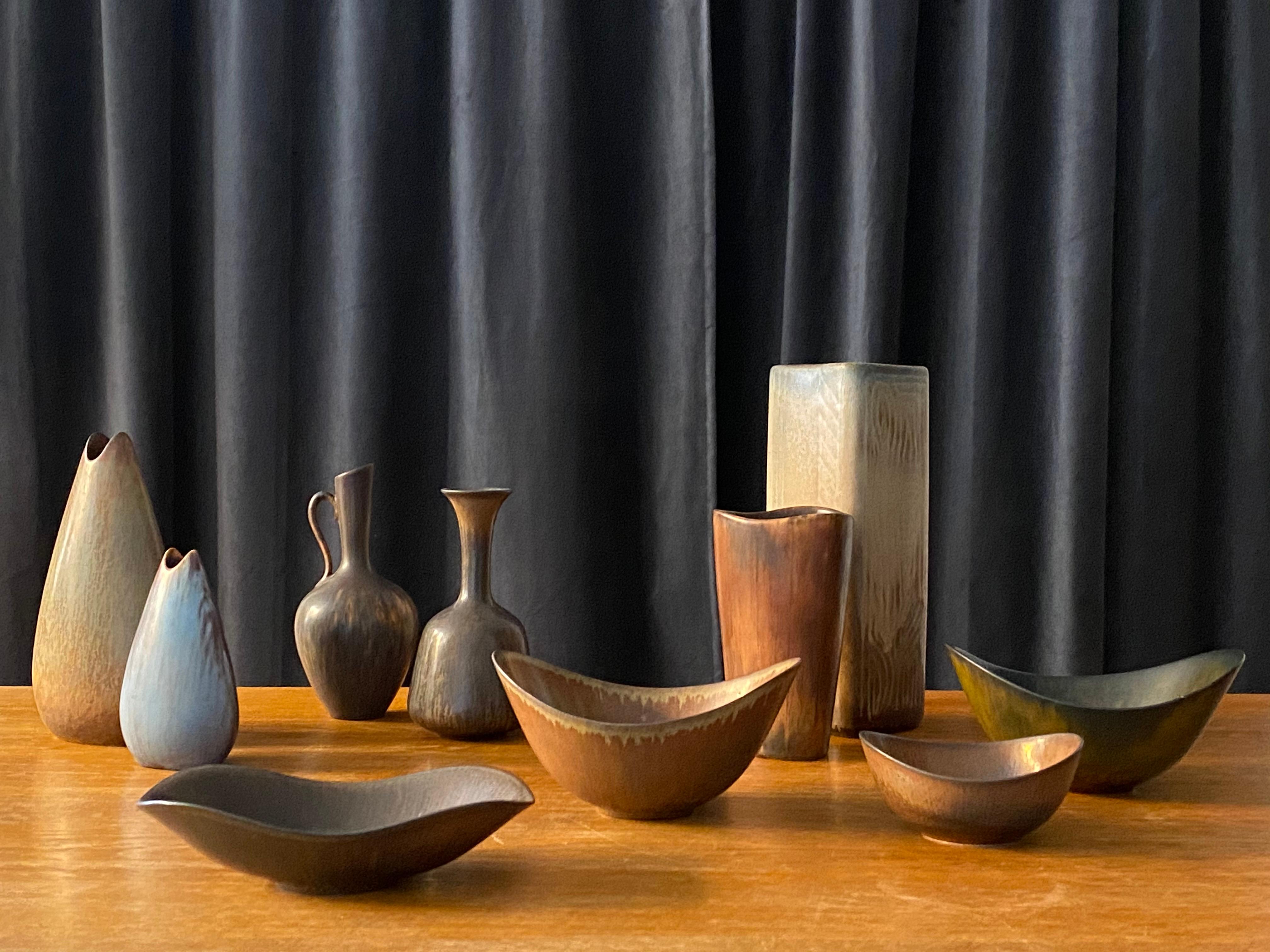 A collection of 10 vases and bowls executed in stoneware and produced by Rörstrands, Sweden, 1940s. Designed and signed by Gunnar Nylund, (Swedish 1914-1997). All vases with highly artistic glazes and colors include brown, black, grey and blue. All