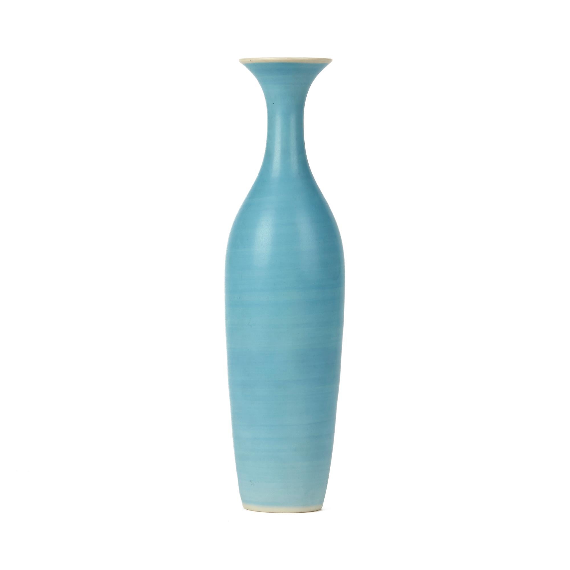 A very stylish vintage Danish porcelain bottle shaped vase decorated in powder blue glazes by Gunnar Nylund (1904-1997) and designed for Nymølle Keramiske Fabrik. This tall elegant vase has a streaked bright blue finish and has printed Nymølle and