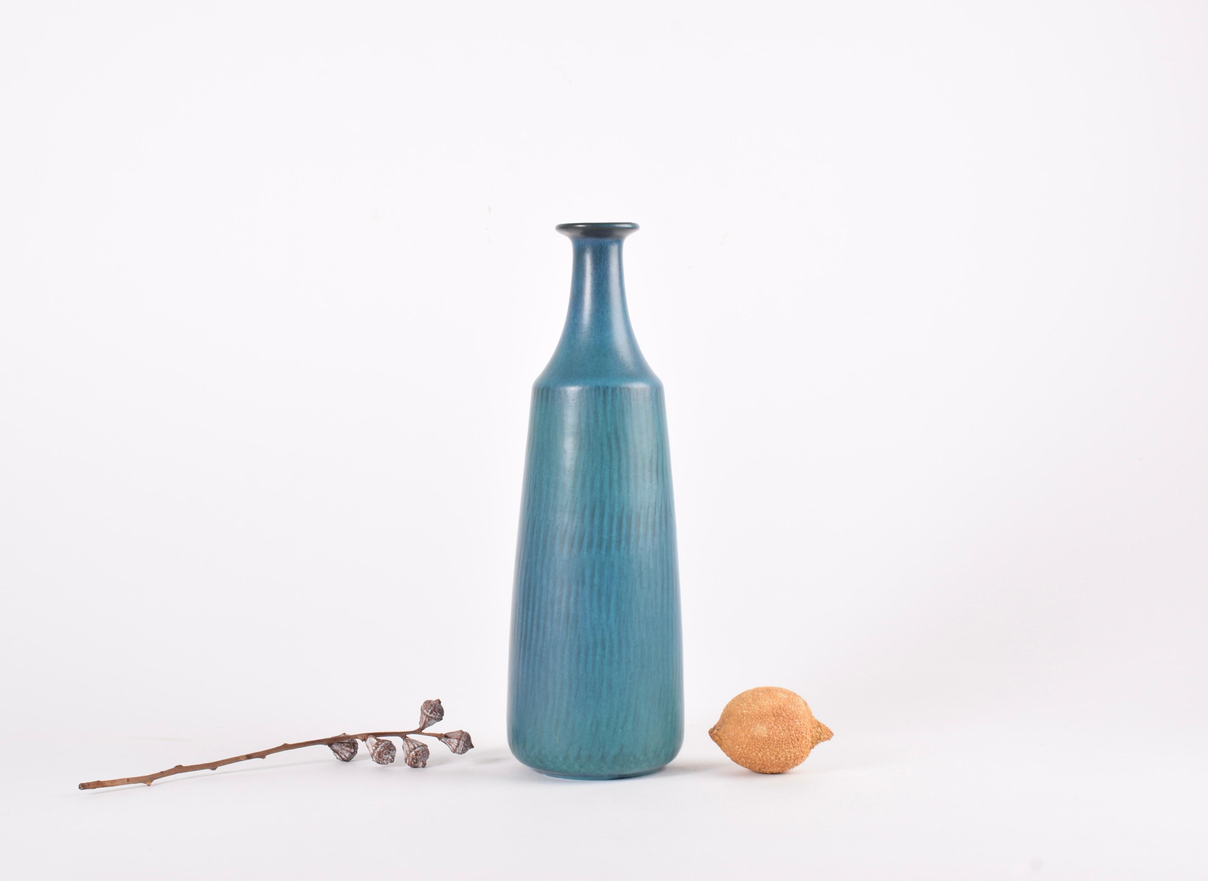 Tall and slender vase designed by Gunnar Nylund for Nymølle, Denmark.  Manufactured circa 1960s. 

The vase has a vivid blue green glaze over a radiating pattern. 

Height: 30,5 cm (12.01