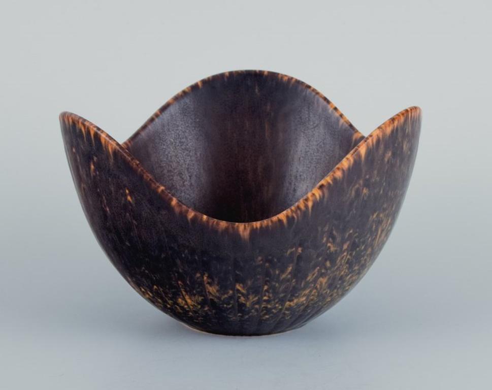 Gunnar Nylund (1904–1997) for Rörstrand. 
Ceramic bowl, organic shape with dark brown and orange glaze.
Mid-20th century.
In perfect condition.
Marked.
Dimensions: D 14.0 x H 9.0 cm.