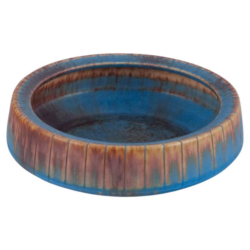 Gunnar Nylund for Rörstrand. Ceramic bowl with glaze in blue and brown tones. For Sale