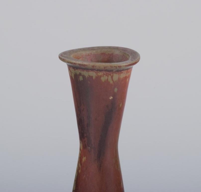 Gunnar Nylund for Rörstrand, Sweden.
Ceramic vase with glaze in brownish tones.
Mid-20th century.
Marked.
First factory quality.
In perfect condition.
Dimensions: H 20.7 cm x D 5.7 cm.