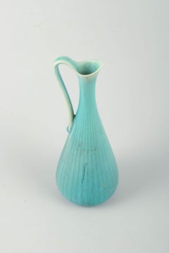 Gunnar Nylund for Rörstrand. Pitcher in turquoise-blue glaze with ribbed body.