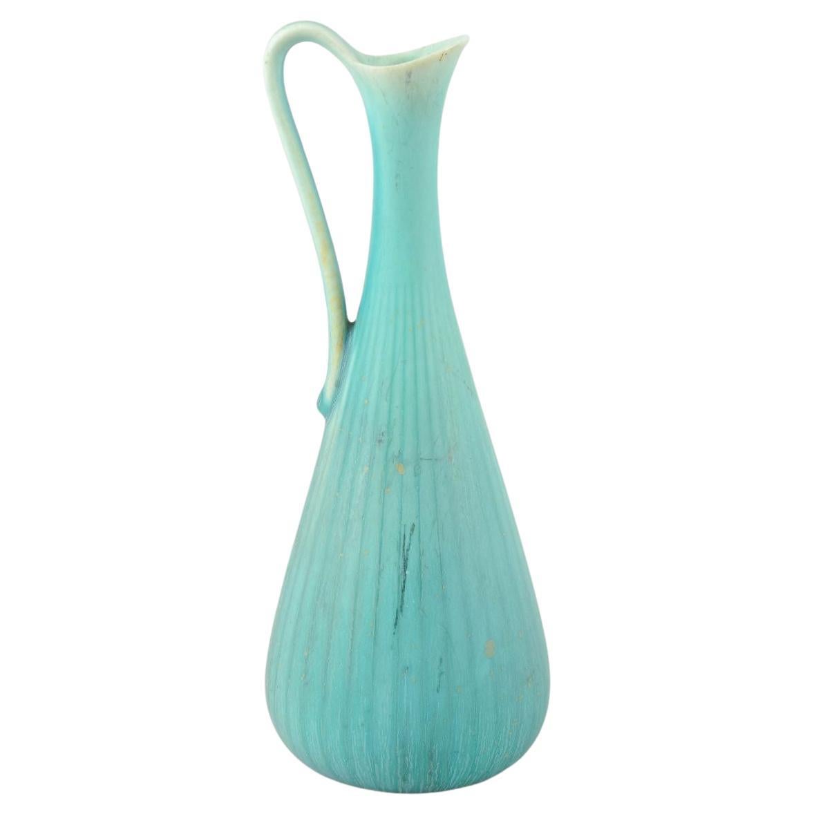 Gunnar Nylund for Rörstrand. Pitcher in turquoise-blue glaze with ribbed body.