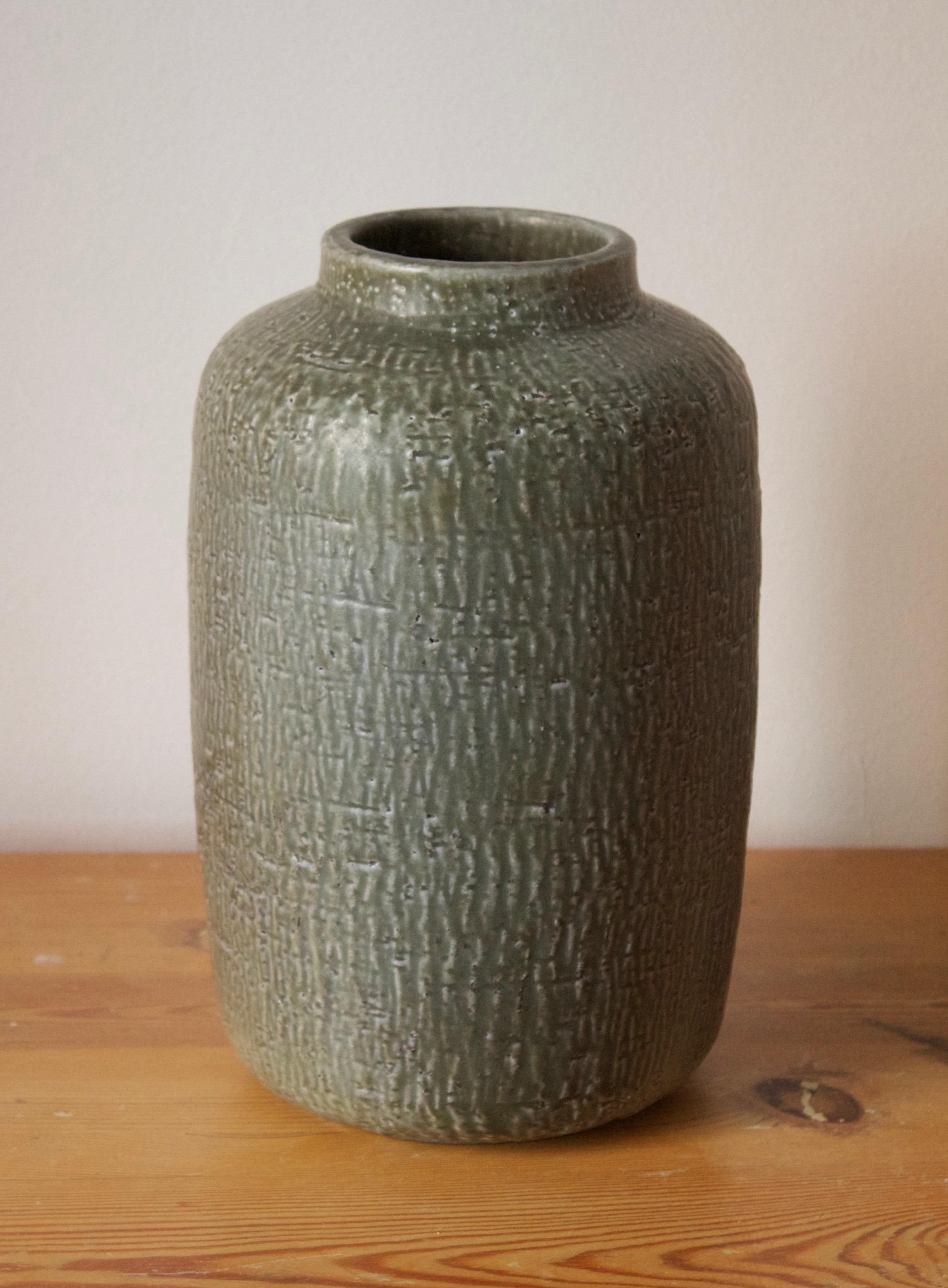 A large vase produced by Nymølle, Denmark, c. 1960s. Designed by Gunnar Nylund, (Swedish, 1914-1997). Signed.

Nylund served as artistic director at Rörstrands, where he worked 1931-1955. Prior to his work at Rörstrand he was a well-established