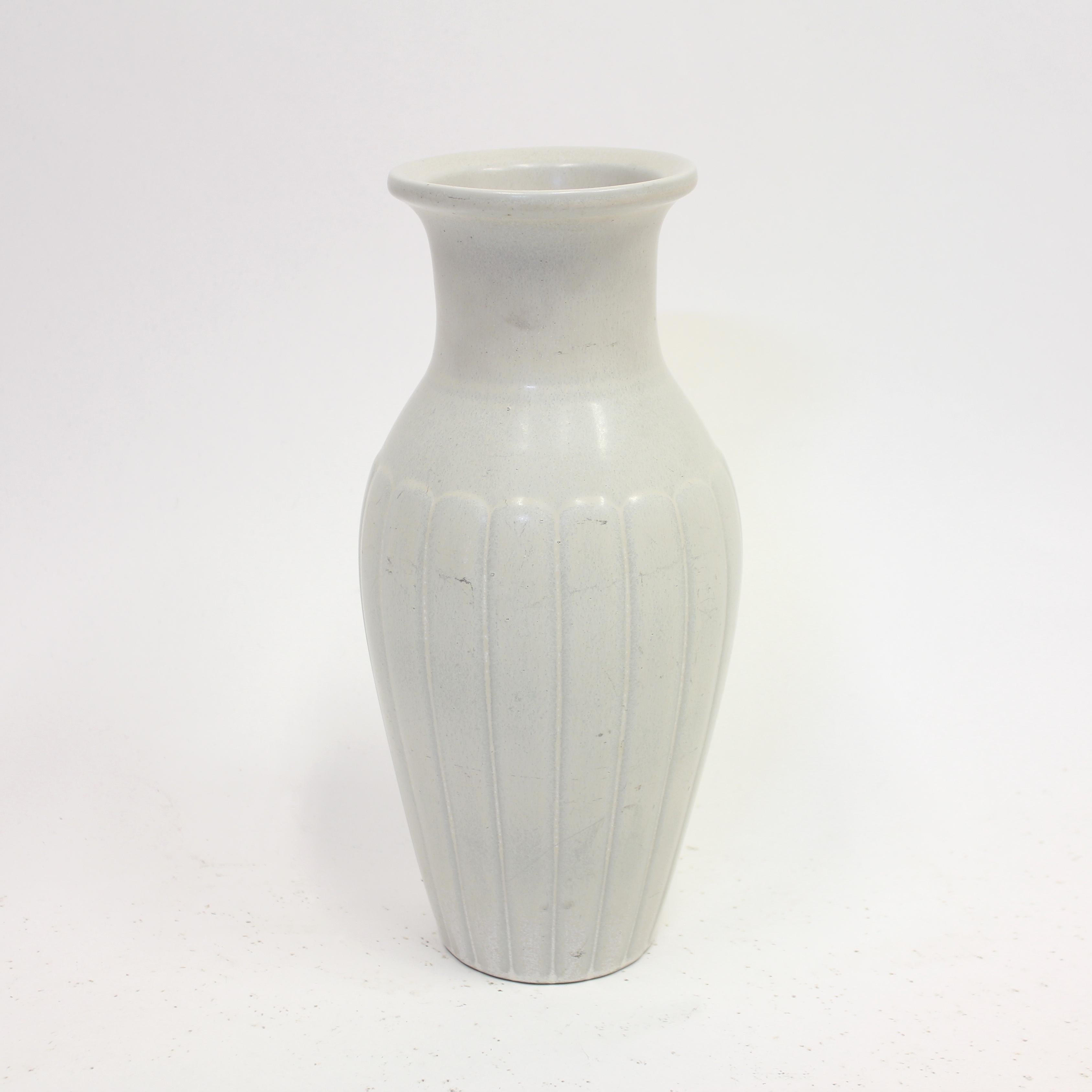 Large white stoneware vase by Swedish ceramicist Gunnar Nylund, produced by Rörstrand in the 1950s. Nice shape with a striped pattern on the lower and wider section. The vase is in an overall good vintage condition with normal ware consistent with