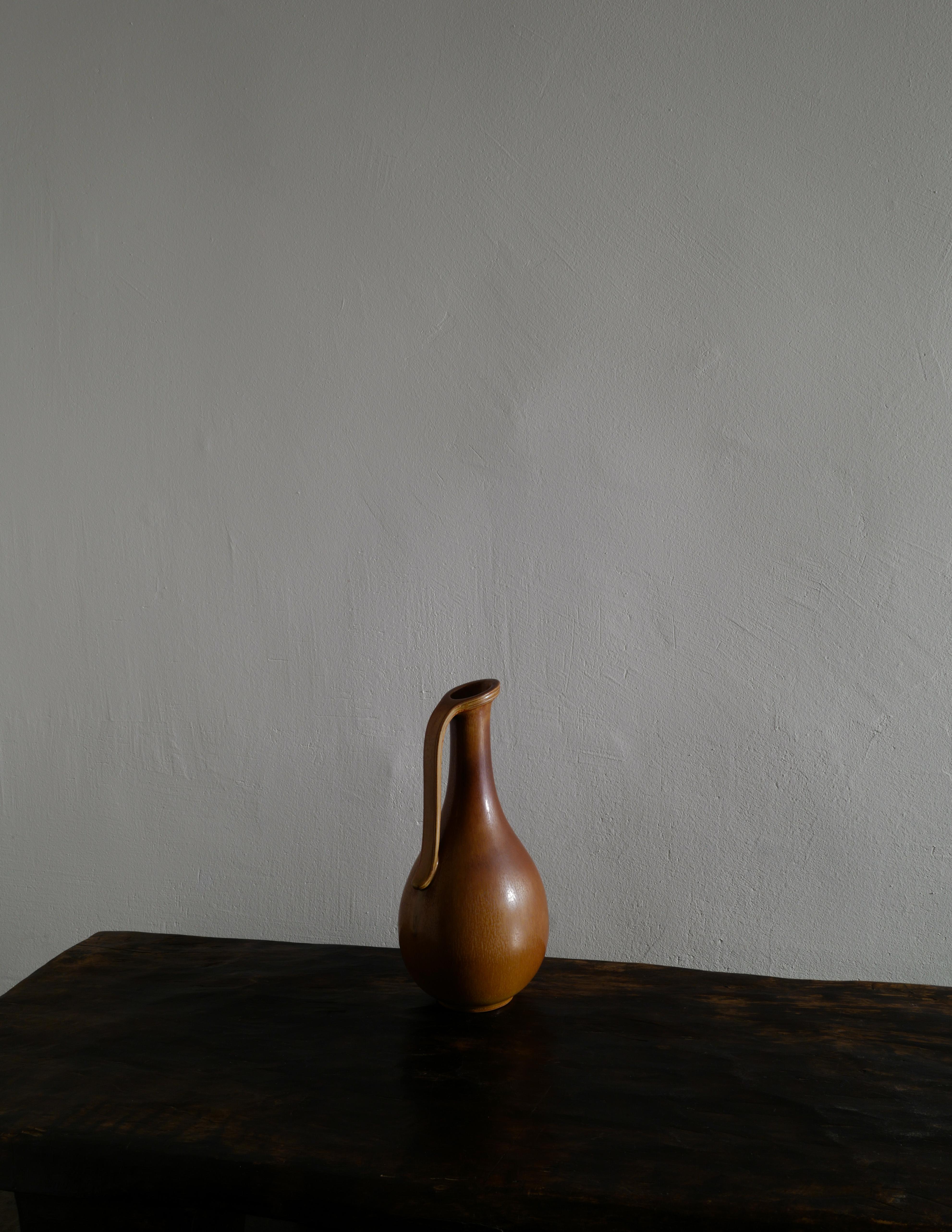 Rare vase-pichet en céramique du milieu du siècle par Gunnar Nylund pour le Studio Rörstrand en Suède, produit dans les années 1950. En bon état vintage avec des signes minimes d'âge et d'utilisation. 

Dimensions : Hauteur : 35 cm.
