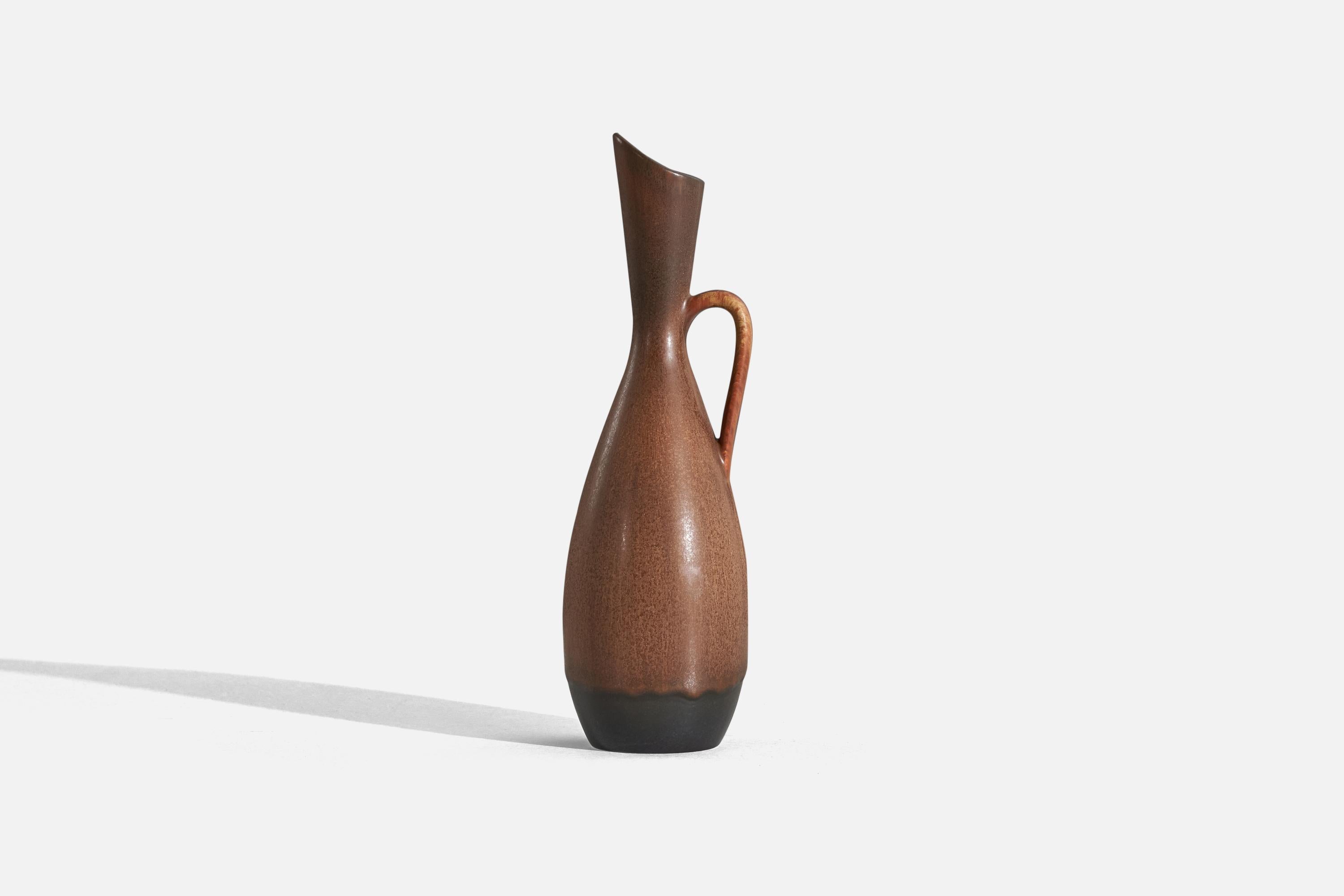 A brown and black, glazed stoneware pitcher, designed by Gunnar Nylund and produced by Rörstrand, Sweden, 1950s.
 