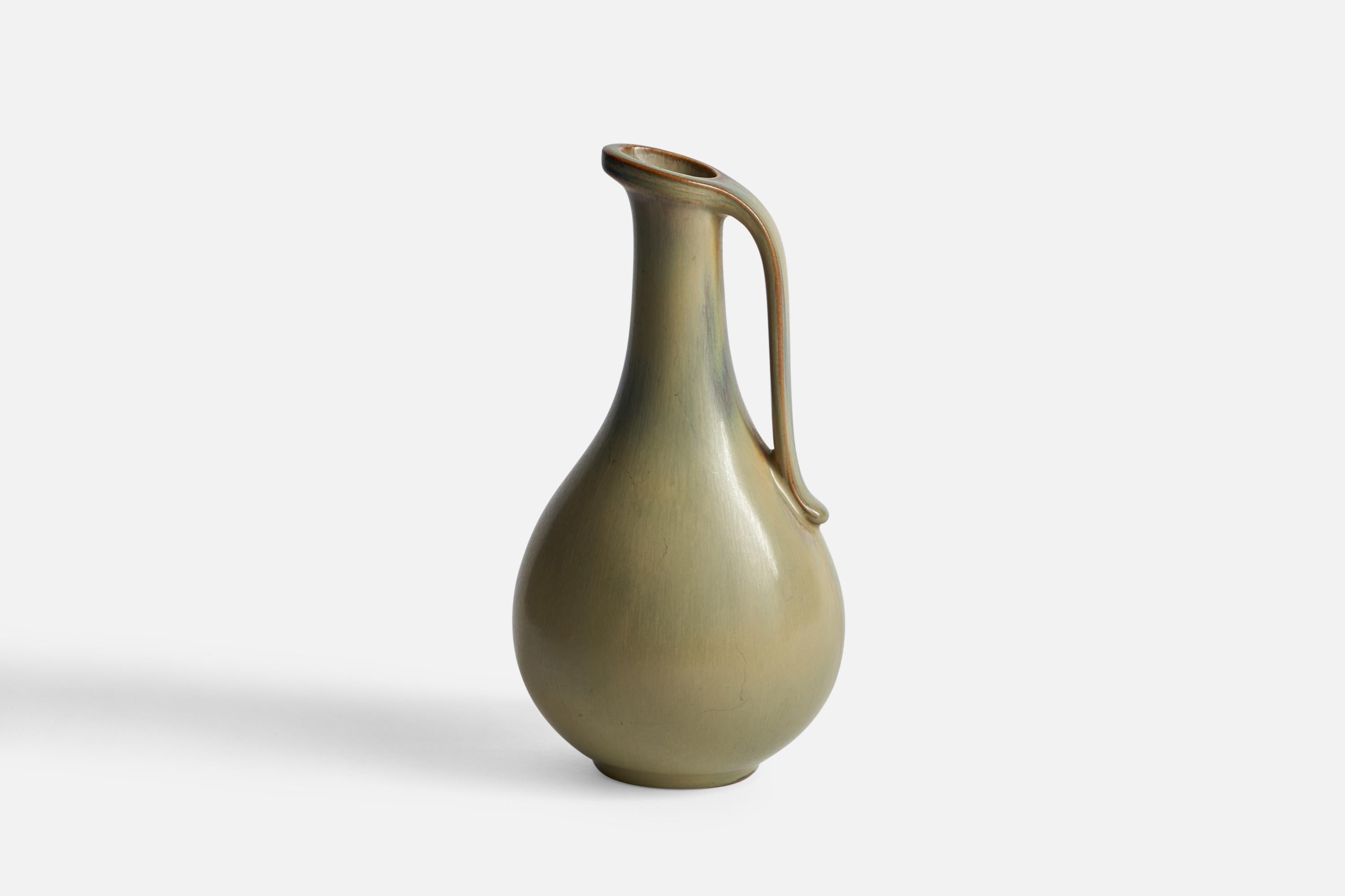 A green-glazed stoneware pitcher designed by Gunnar Nylund and produced by Rörstrand, Sweden, 1940s.