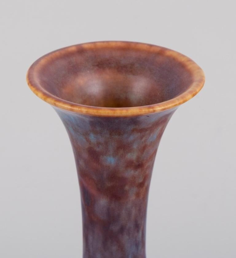 Scandinavian Modern Gunnar Nylund, Rörstrand. Ceramic vase with a narrow neck in blue-violet glaze For Sale