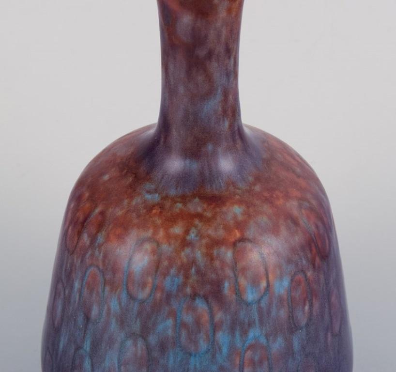 Swedish Gunnar Nylund, Rörstrand. Ceramic vase with a narrow neck in blue-violet glaze For Sale