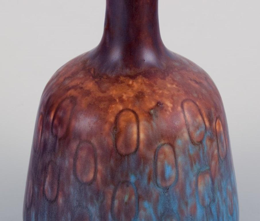 Glazed Gunnar Nylund, Rörstrand. Ceramic vase with a narrow neck in blue-violet glaze For Sale