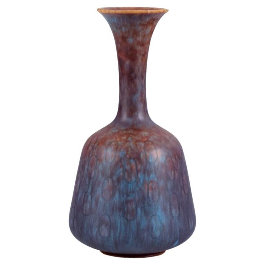 Gunnar Nylund, Rörstrand. Ceramic vase with a narrow neck in blue-violet glaze For Sale