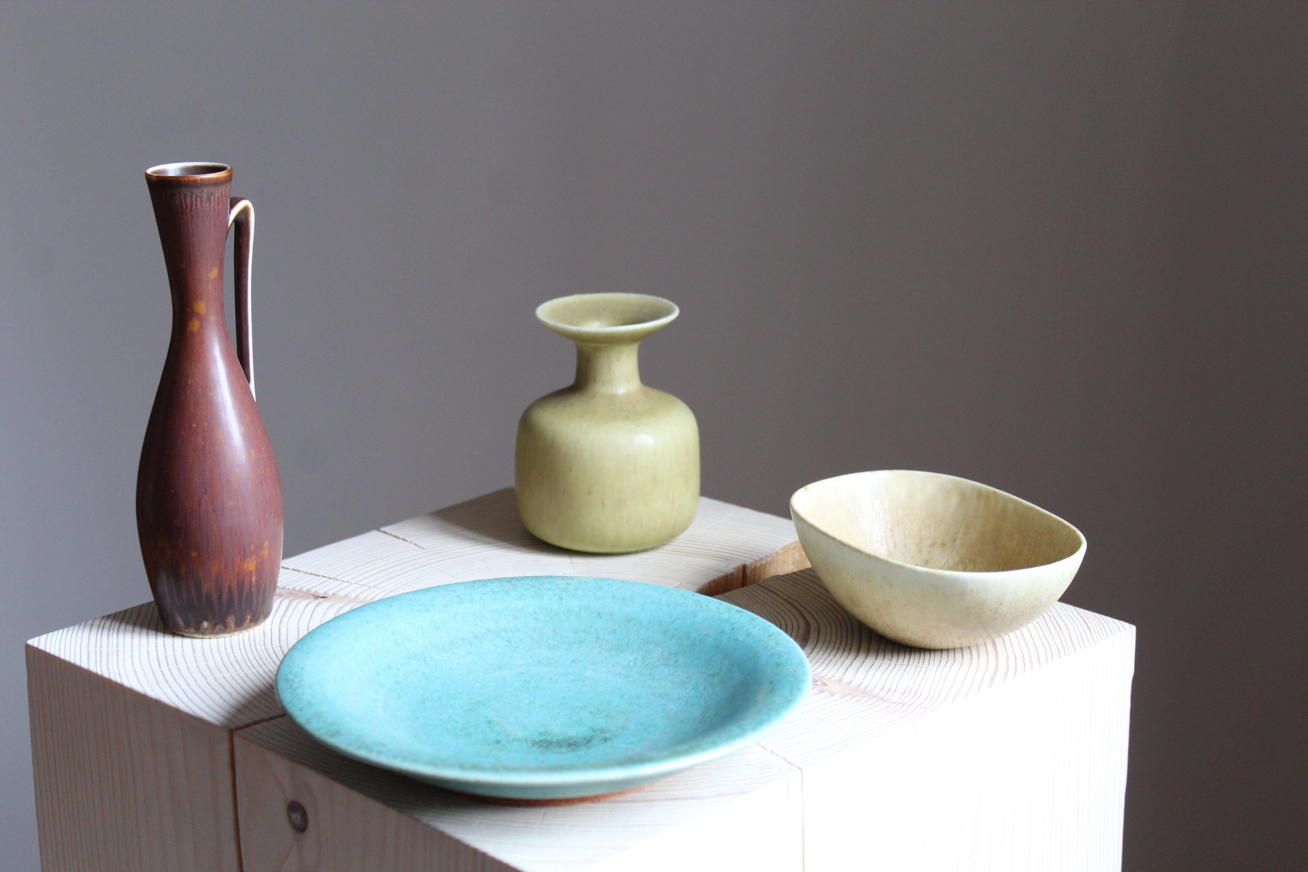An assorted collection of small works in stoneware. Pitcher, bowl and vase by Gunnar Nylund for Rörstrand, Sweden, 1950s. Plate, 1950s, produced by Saxbo, the Danish producer that was co-founded by Gunnar Nylund.


Other ceramicists of the period