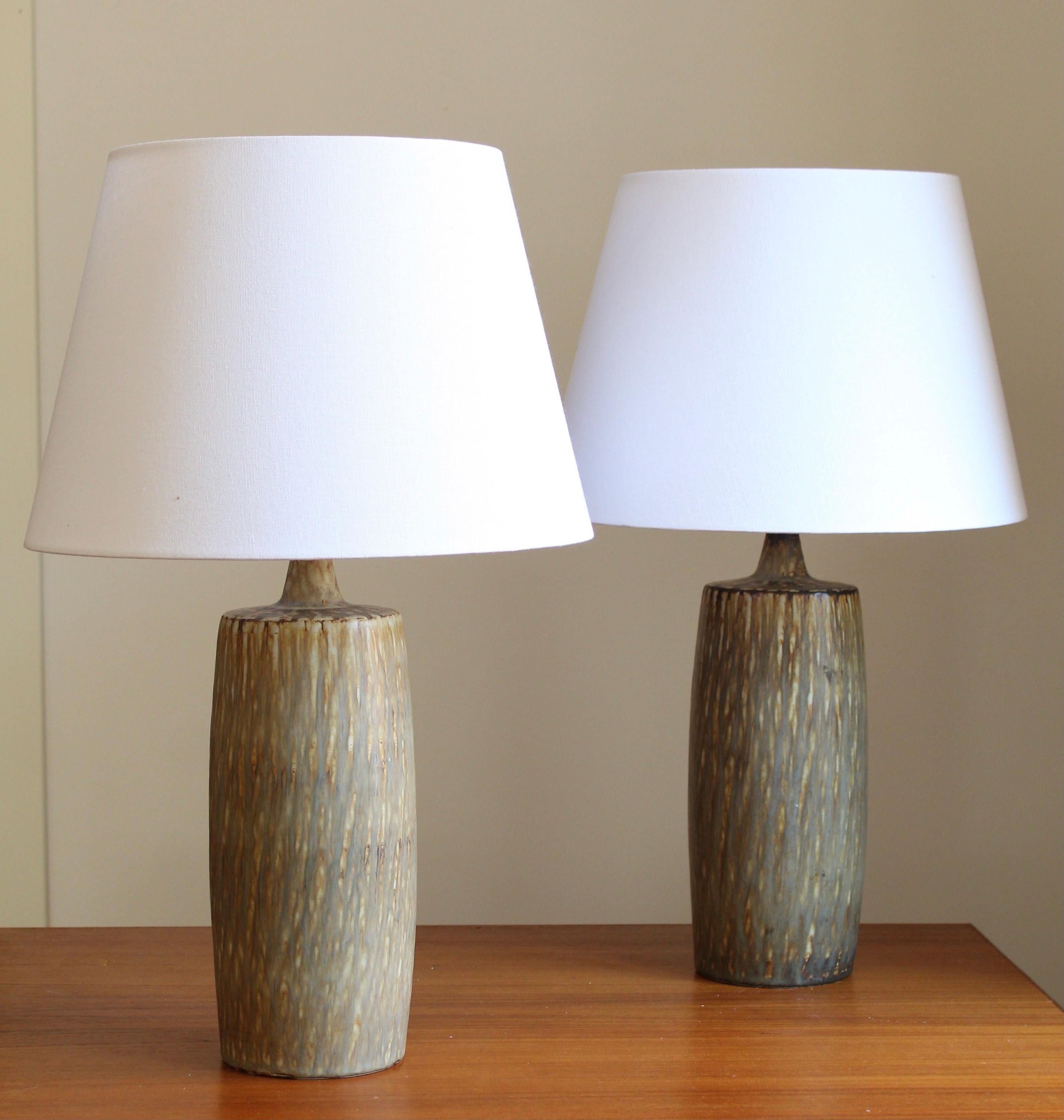 A pair of table lamps produced by Rörstrand, Sweden, 1950s. Designed by Gunnar Nylund, (Swedish, 1914-1997). Signed. Brand new lampshades. Sourced from one estate.

Nylund served as artistic director at Rörstrand, where he worked, 1931-1955. Prior