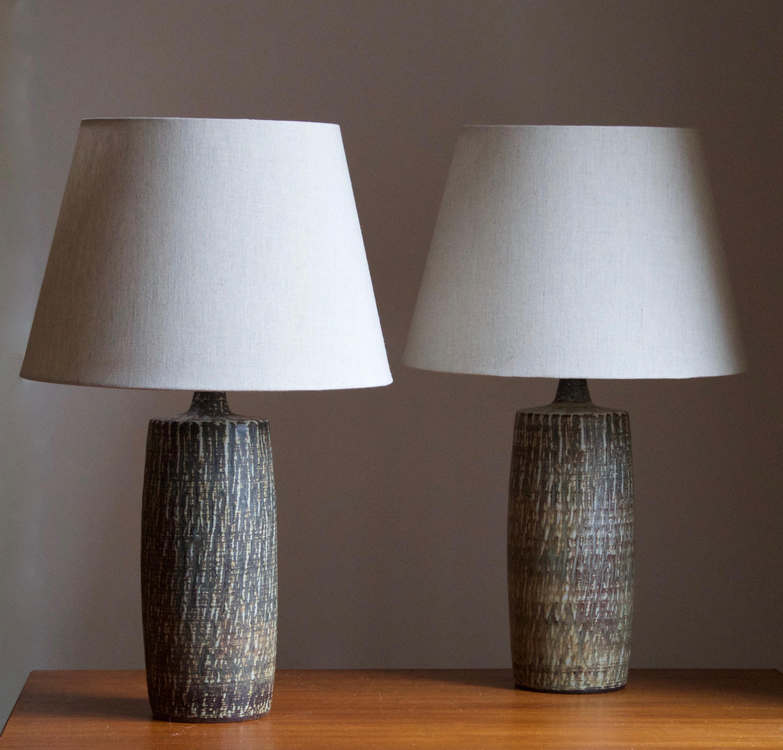 A pair of table lamps produced by Rörstrand, Sweden, 1950s. Designed by Gunnar Nylund, (Swedish, 1914-1997). Signed. 

Sold without lampshades. Stated dimensions exclude lampshade, height includes socket.

Nylund served as artistic director at