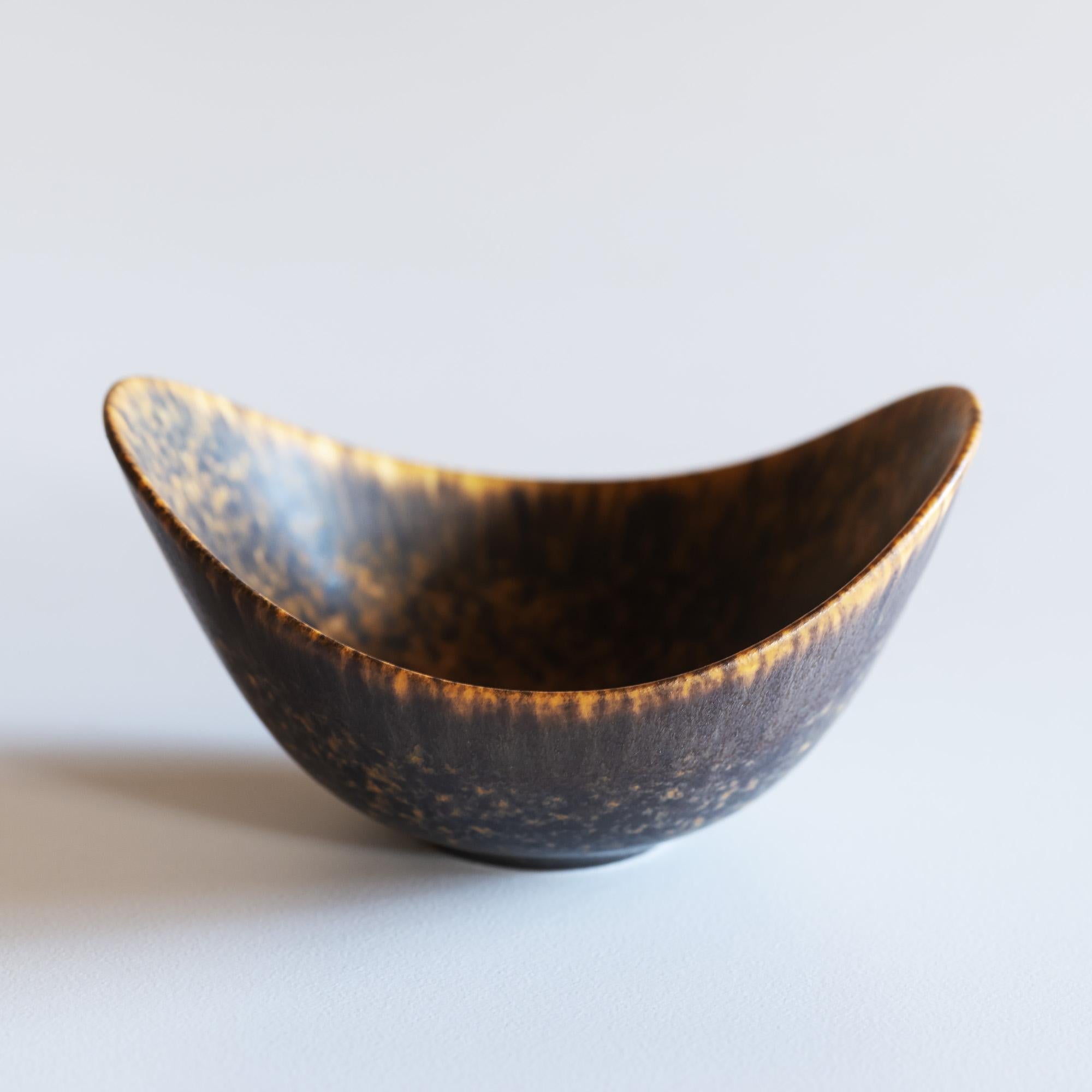 Single Gunnar Nylund stoneware vessel for Rörstrand, Sweden. Matte hares fur glaze in brown and black tones with golden accents.
       