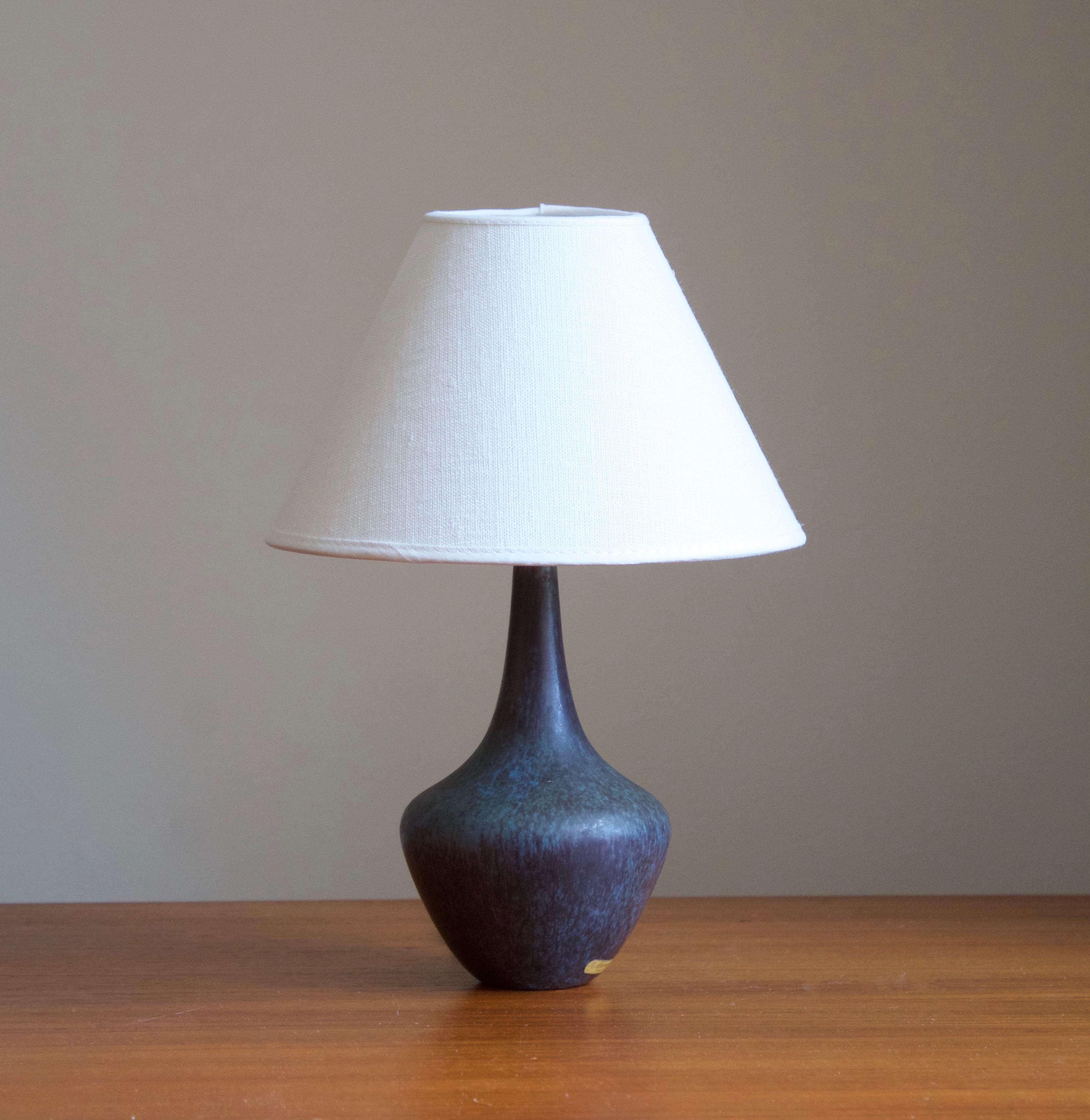 A table lamp produced by Rörstrand, Sweden, 1950s. Designed by Gunnar Nylund, (Swedish, 1914-1997). Signed. Labeled

Stated dimensions exclude lampshade, height includes socket. Sold without lampshade.

Nylund served as artistic director at