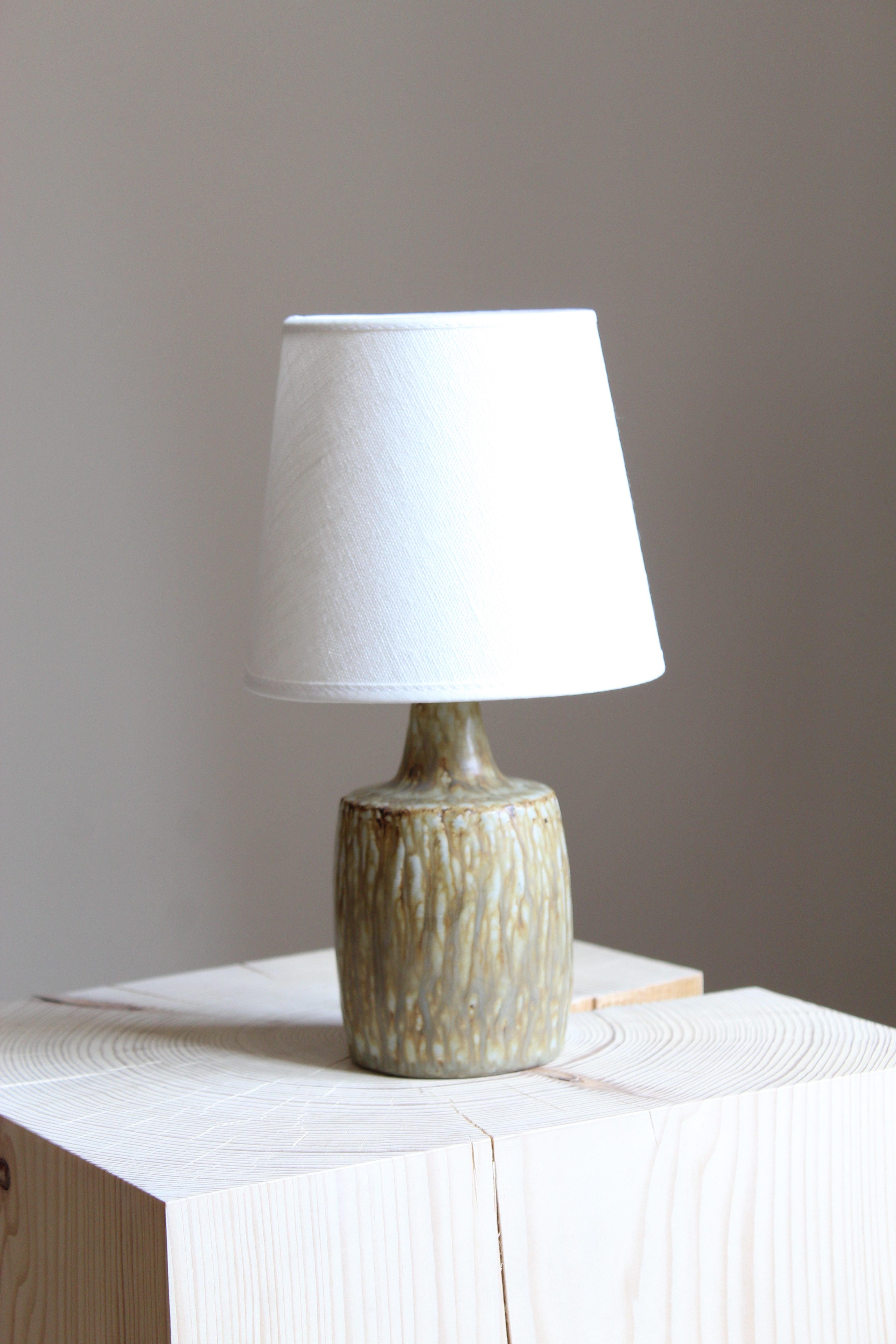 A table lamp produced by Rörstrand, Sweden, 1950s. Designed by Gunnar Nylund, (Swedish, 1914-1997). Signed. Sold without lampshade.

Nylund served as artistic director at Rörstrand, where he worked, 1931-1955. Prior to his work at Rörstrand he was a