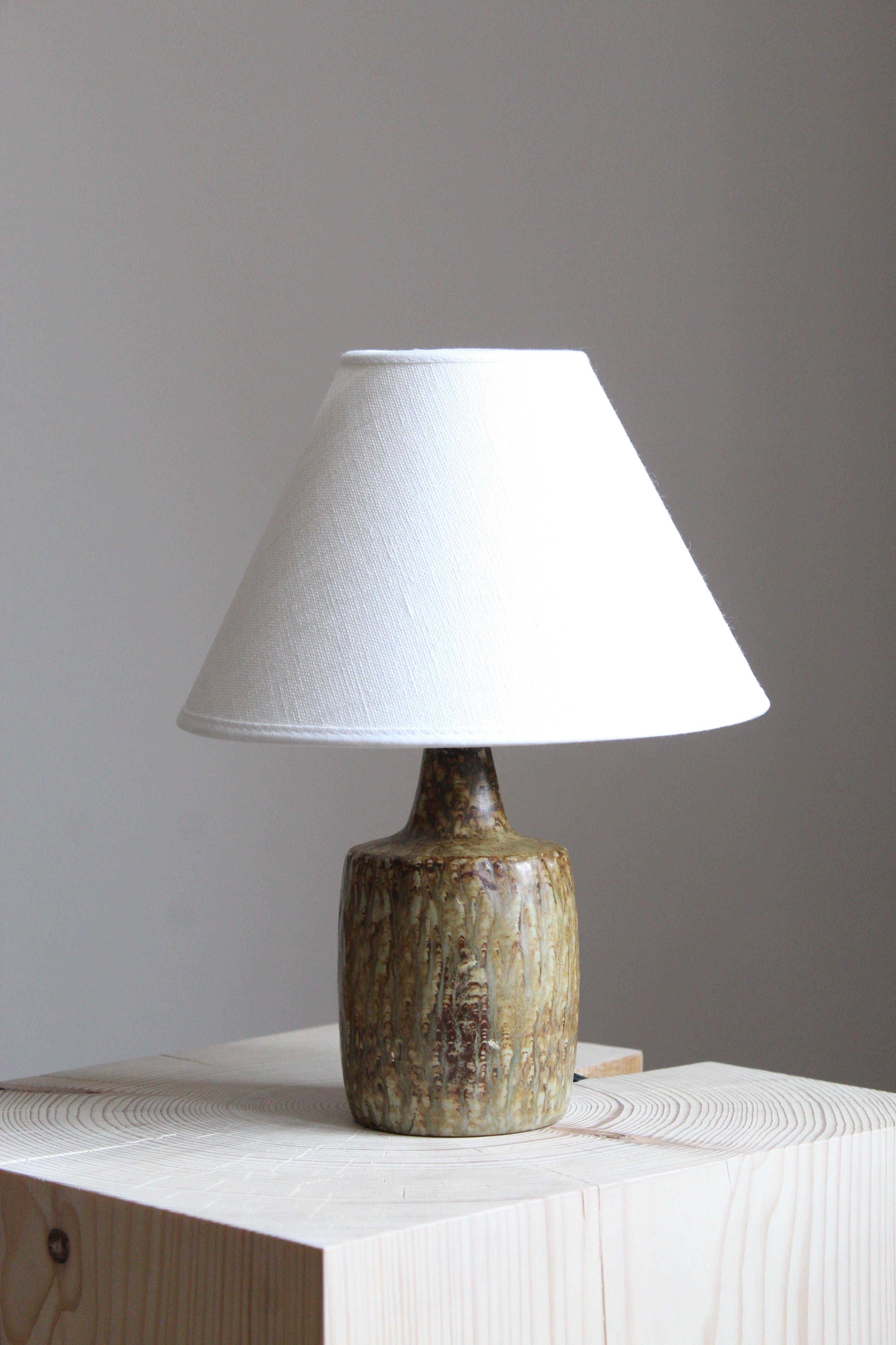 A table lamp produced by Rörstrand, Sweden, 1950s. Designed by Gunnar Nylund, (Swedish, 1914-1997). Signed.

Stated dimensions exclude lampshade, height includes socket. Sold without lampshade.

Nylund served as artistic director at Rörstrand, where