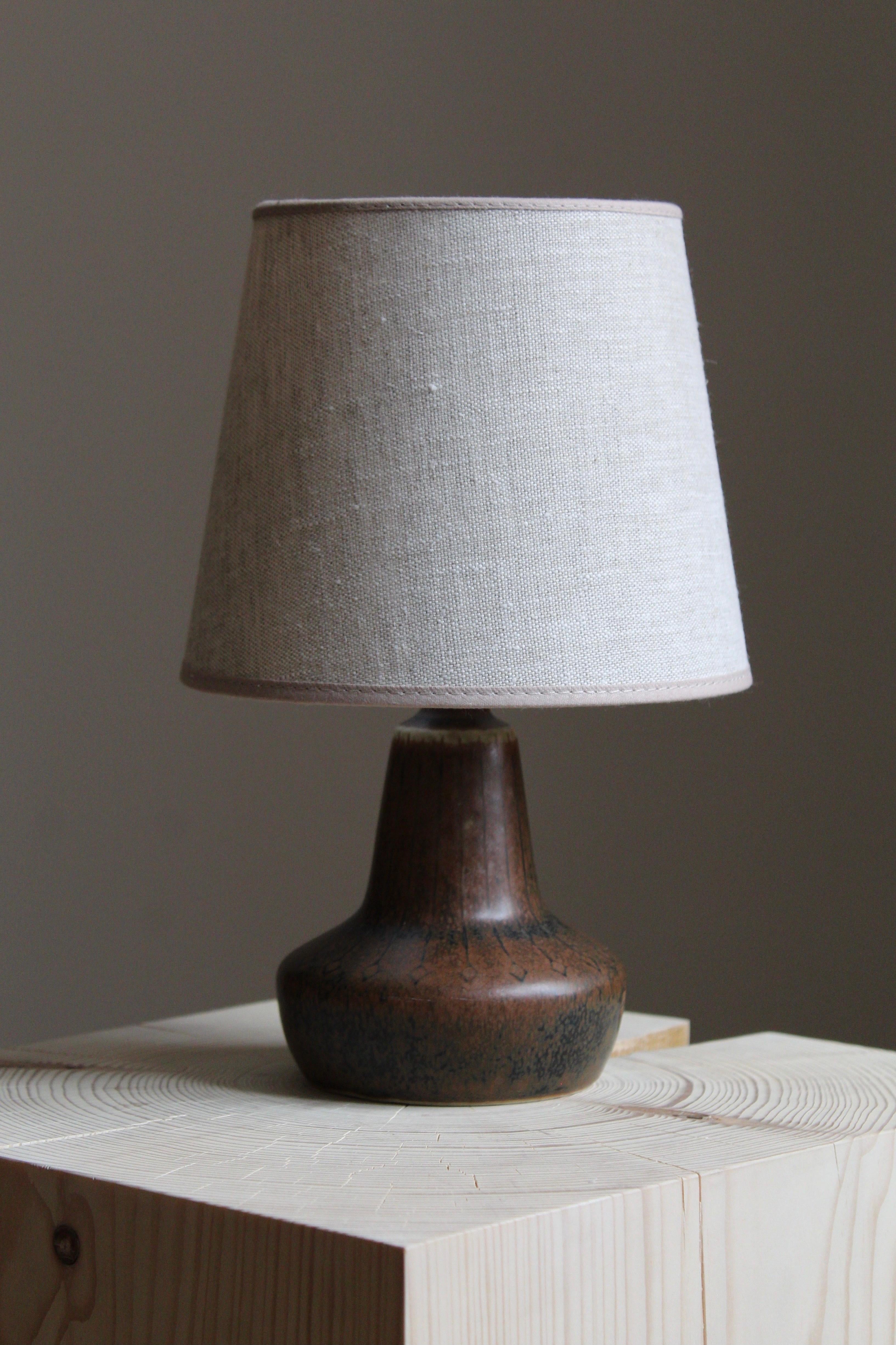 A table lamp produced by Rörstrand, Sweden, 1950s. Designed by Gunnar Nylund, (Swedish, 1914-1997). Signed. Lampshade not included.

Nylund served as artistic director at Rörstrand, where he worked, 1931-1955. Prior to his work at Rörstrand he was a