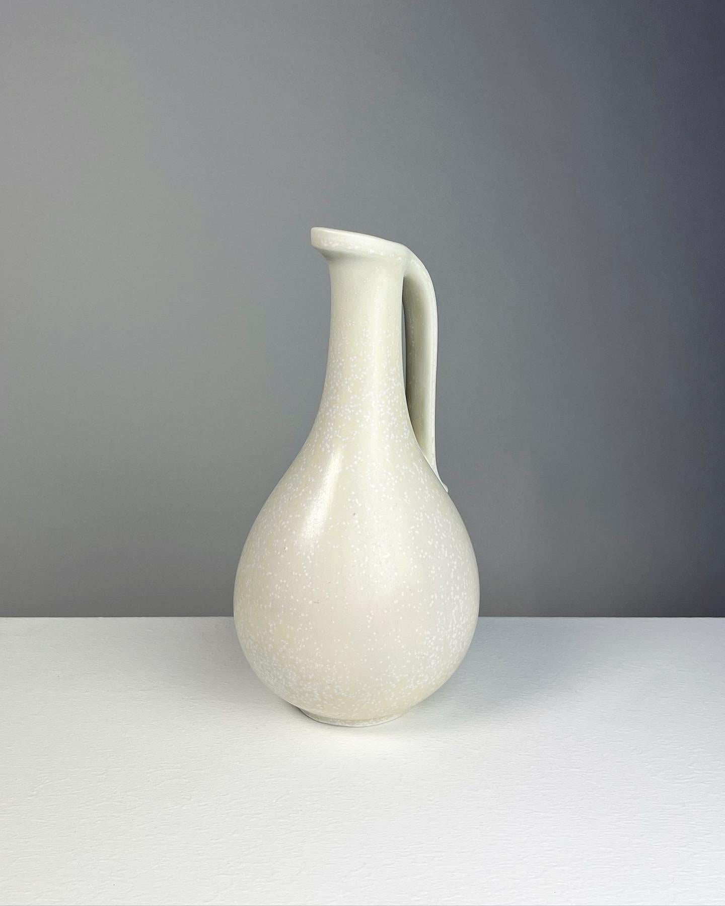 Beautiful stoneware pitcher vase by Gunnar Nylund, model No. 250 for Rörstrand in Sweden, 1950s.

Hand-thrown stoneware with a beautiful eggshell mimosa glaze. Signed underneath with the creators initials. 

Height: 24.5 cm
Diameter: 13 cm.
