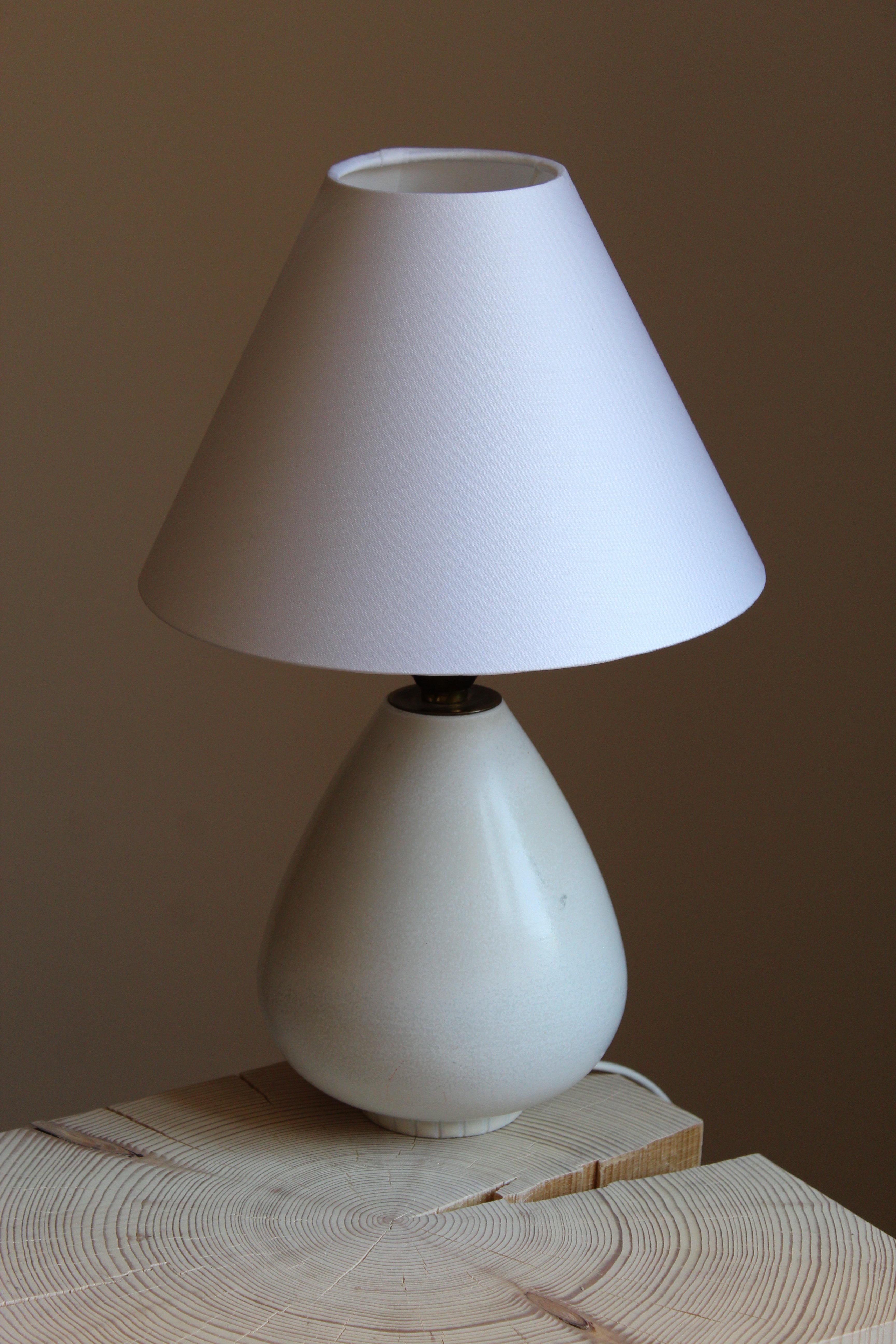A table lamp produced by Rörstrand, Sweden, 1950s. Designed by Gunnar Nylund, (Swedish, 1914-1997). Signed. 

Sold without lampshade. Stated dimensions excluding lampshade. 

Nylund served as artistic director at Rörstrand, where he worked,