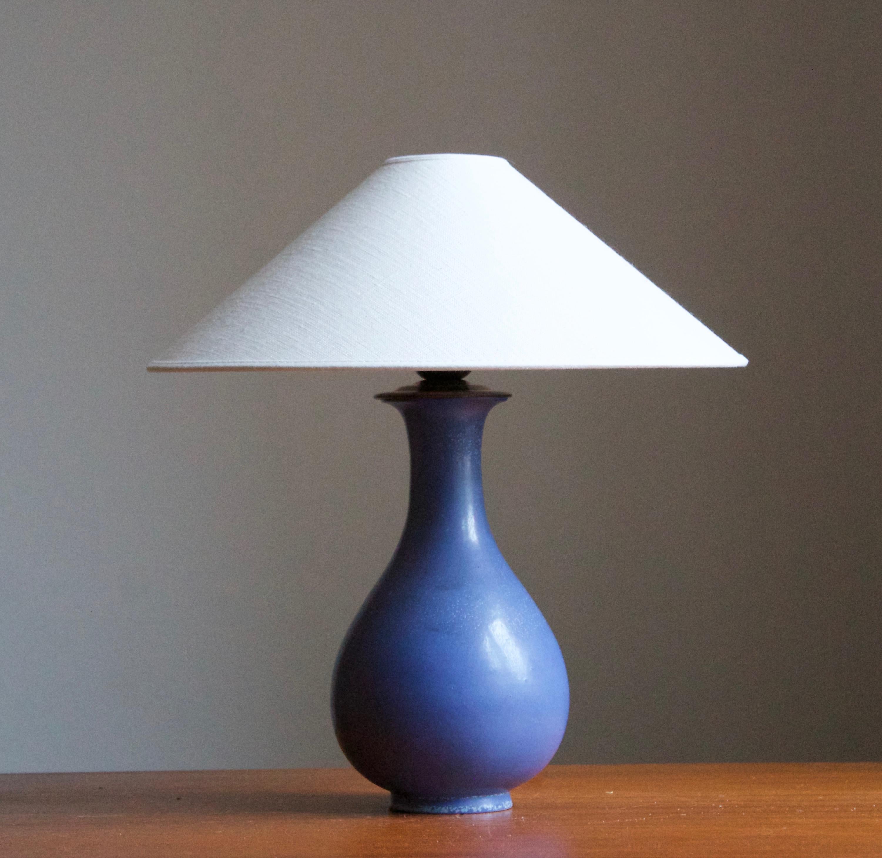 A table lamp produced by Rörstrand, Sweden, 1950s. Designed by Gunnar Nylund, (Swedish, 1914-1997). Signed. 

Sold without lampshade. Stated dimensions exclude lampshade, height includes socket.

Nylund served as artistic director at Rörstrand,