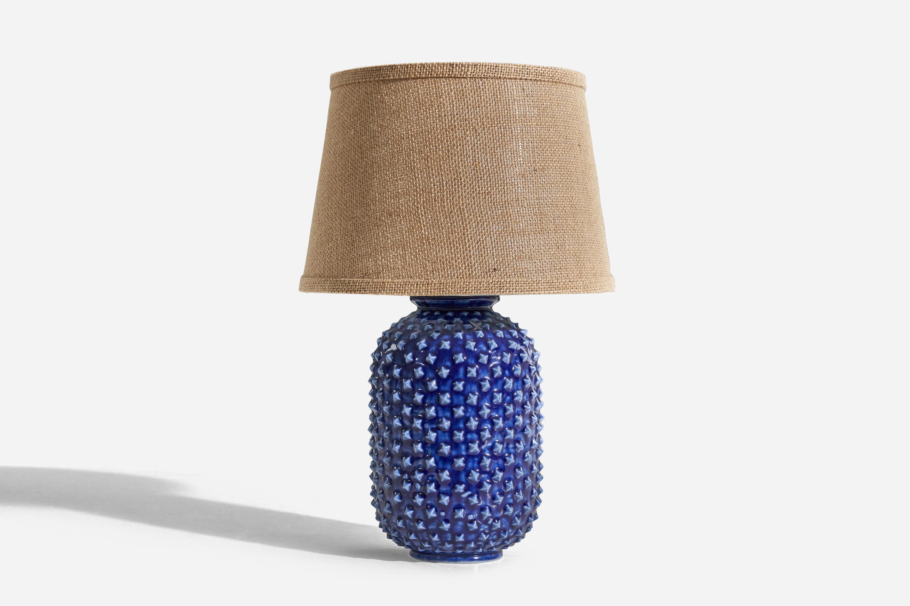 A blue, glazed stoneware table lamp designed by Gunnar Nylund and produced by Rörstrand, Sweden, 1950s. 

Sold without lampshade. 
Dimensions of Lamp (inches) : 12 x 5.93 x 5.93 (H x W x D)
Dimensions of Shade (inches) : 8 x 10.25 x 7 (T x B x
