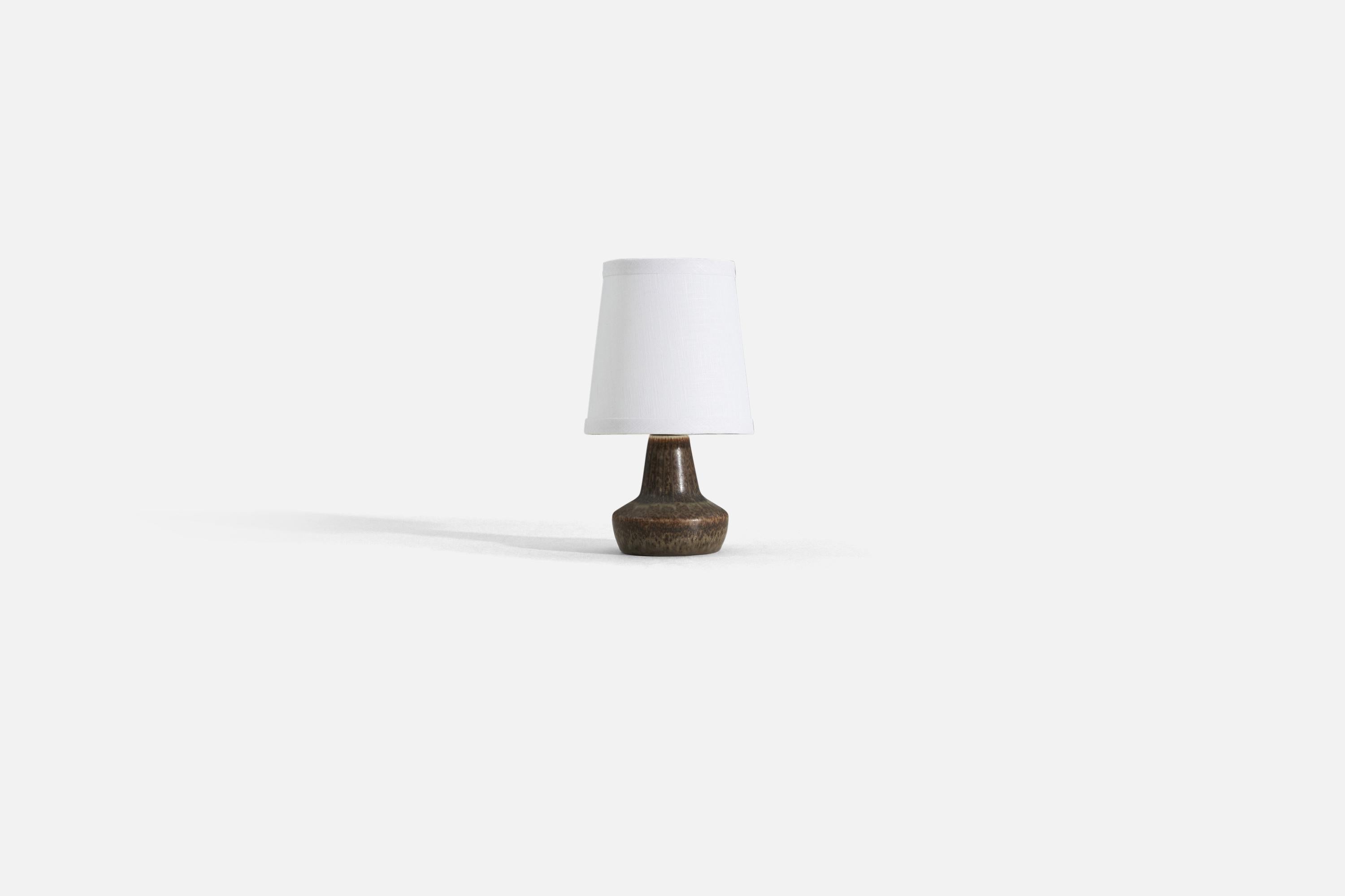 A brown glazed stoneware table lamp produced by Rörstrand, Sweden, 1950s. Designed by Gunnar Nylund, (Swedish, 1914-1997). 

Sold without lampshade. Stated dimensions exclude lampshade, height includes socket.

For reference:

Shade : 4.5 x 6