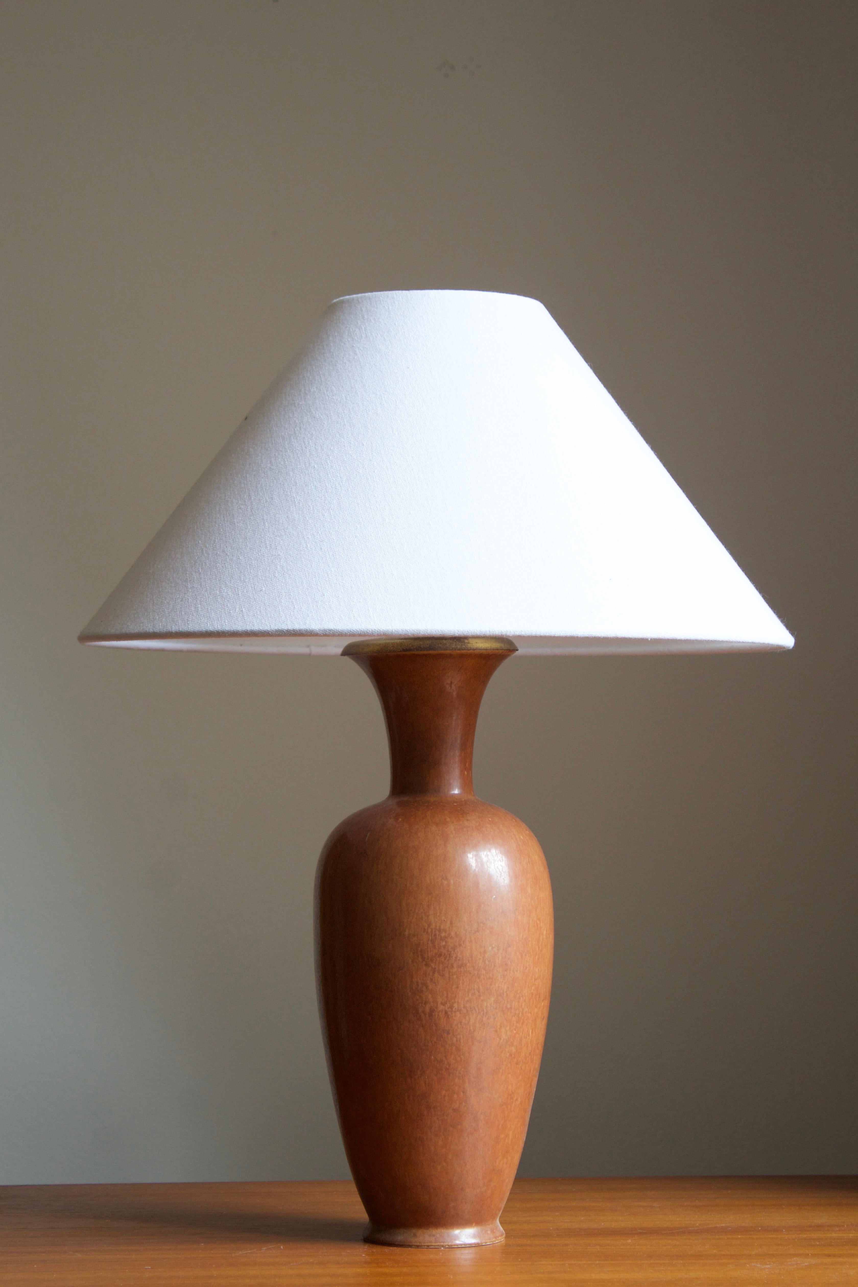 A table lamp produced by Rörstrand, Sweden, 1950s. Designed by Gunnar Nylund, (Swedish, 1914-1997). Signed. 

Stated dimensions exclude lampshade, height includes socket. Sold without lampshade.

Nylund served as artistic director at Rörstrand,
