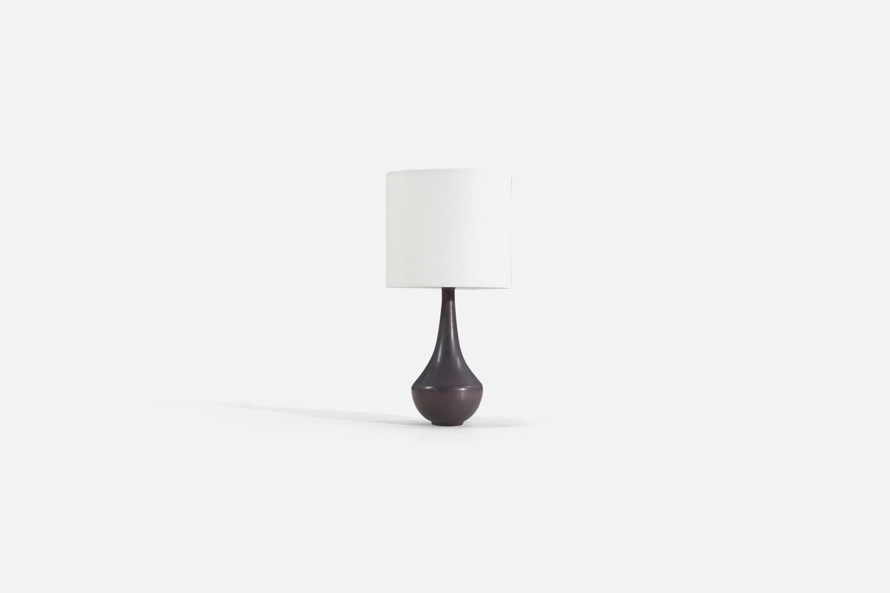 A table lamp produced by Rörstrand, Sweden, 1950s. Designed by Gunnar Nylund, (Swedish, 1914-1997). Signed on base. 

Sold without lampshade. Stated dimensions exclude lampshade, height includes socket.

For reference:

Shade : 6 x 6 x