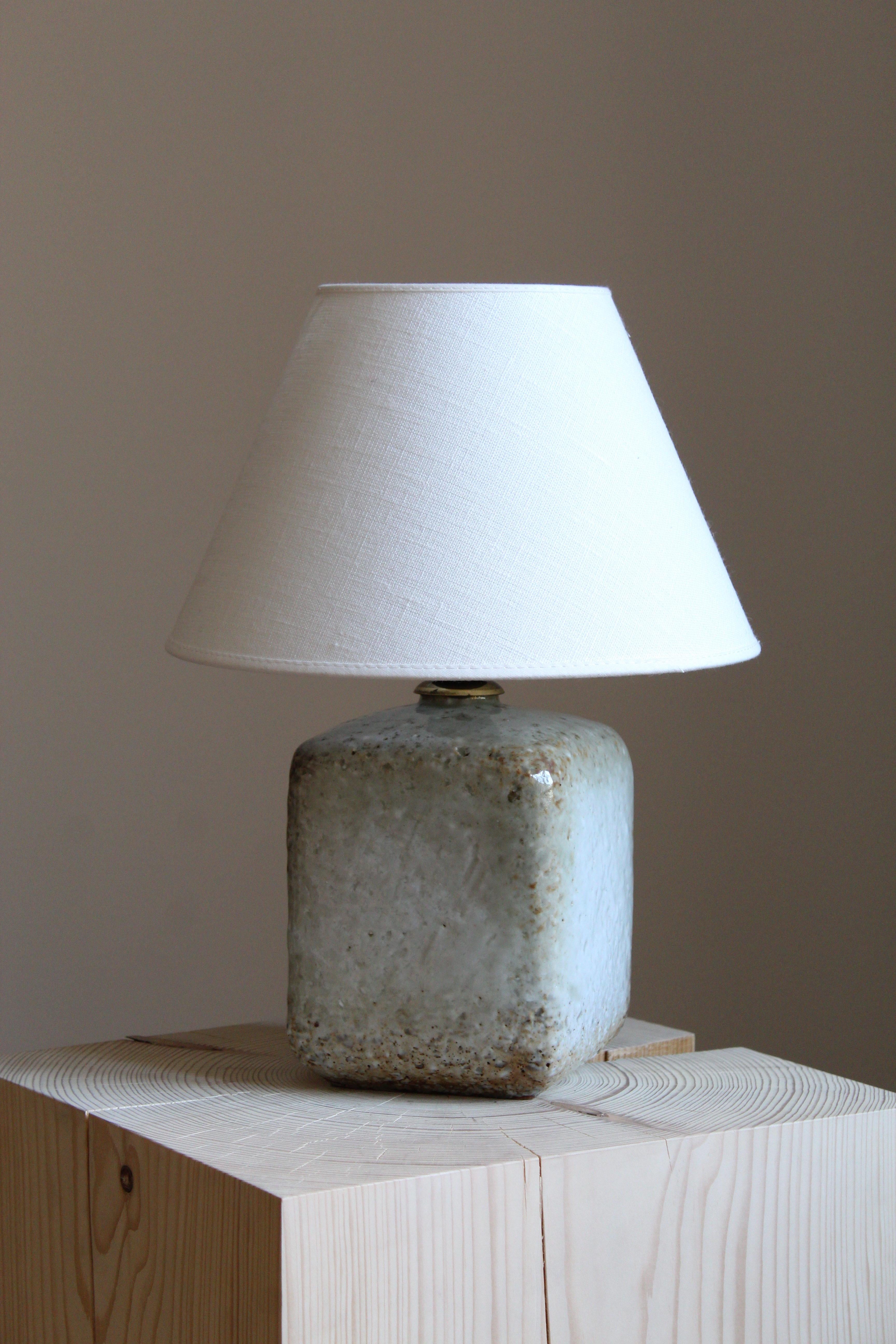 A table lamp produced by Rörstrand, Sweden, 1950s. Designed by Gunnar Nylund, (Swedish, 1914-1997). Signed. With brand new lampshade.

Nylund served as artistic director at Rörstrand, where he worked, 1931-1955. Prior to his work at Rörstrand he