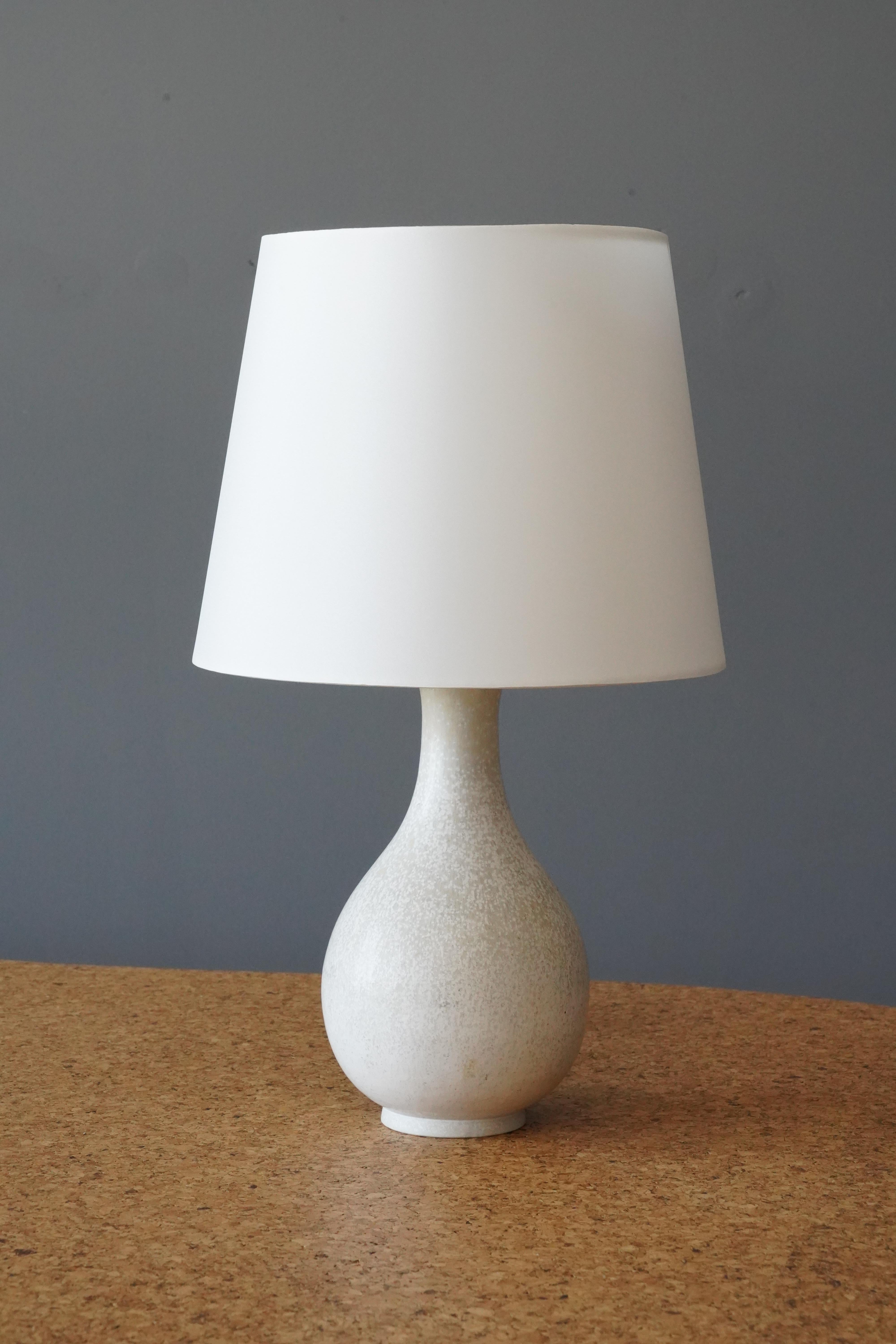 A table lamp produced by Rörstrand, Sweden, 1950s. Designed by Gunnar Nylund, (Swedish, 1914-1997). Signed. 

Stated dimensions exclude lampshade, height includes socket.  Sold without lampshade.

With the shade, it is 16.75