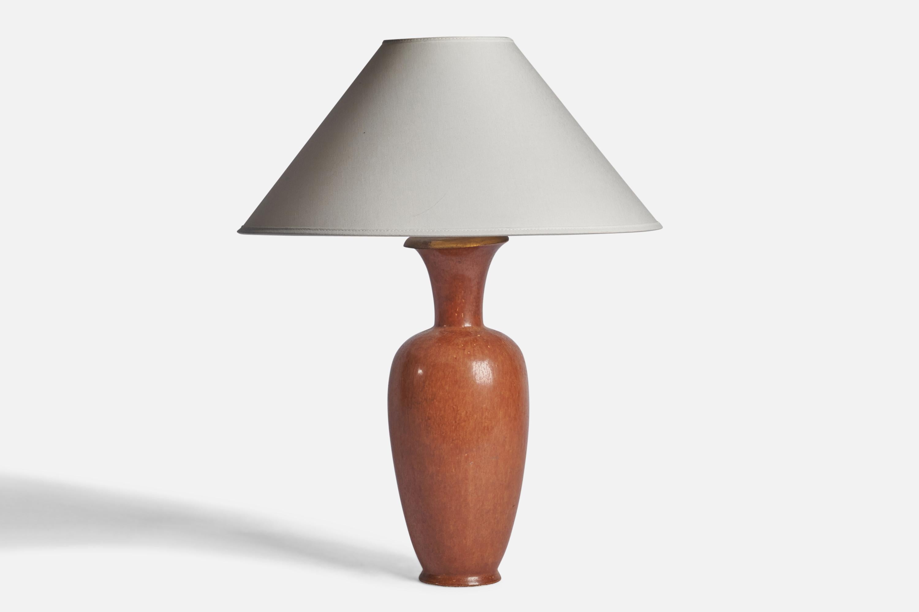 A brown-glazed stoneware and brass table lamp designed by Gunnar Nylund and produced by Rörstrand, Sweden, 1940s.

Dimensions of Lamp (inches): 15.75” H x 5” Diameter
Dimensions of Shade (inches): 4.5” Top Diameter x 16” Bottom Diameter x 7.25”