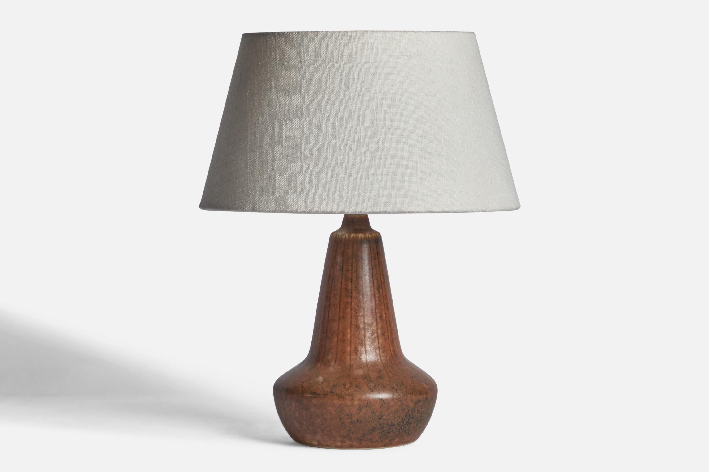 A small brown-glazed stoneware table lamp designed by Gunnar Nylund and produced by Rörstrand, Sweden, 1940s.

Dimensions of Lamp (inches): 10” H x 5.25” Diameter
Dimensions of Shade (inches): 7” Top Diameter x 10” Bottom Diameter x