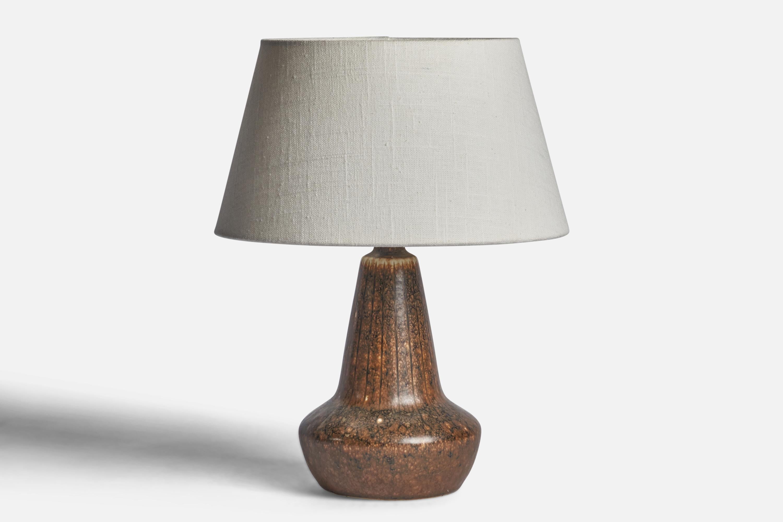 A brown-glazed stoneware table lamp designed by Gunnar Nylund and produced by Rörstrand, Sweden, 1940s.

Dimensions of Lamp (inches): 9.75” H x 5.5” Diameter
Dimensions of Shade (inches): 7” Top Diameter x 10” Bottom Diameter x 5.5” H 
Dimensions of