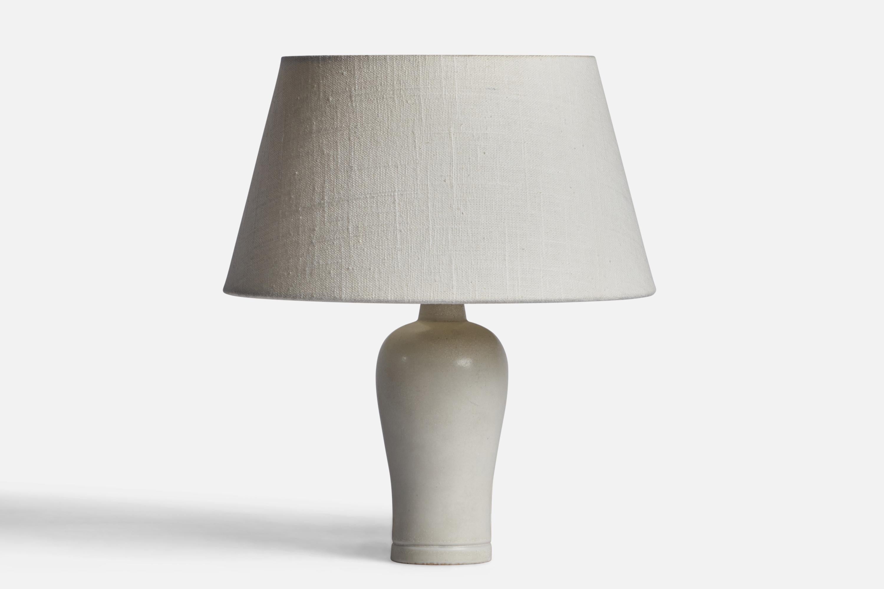 An off-white glazed stoneware table lamp designed by Gunnar Nylund and produced by Rörstrand, Sweden, 1940s.

Dimensions of Lamp (inches): 8.5” H x 3” Diameter
Dimensions of Shade (inches): 7” Top Diameter x 10” Bottom Diameter x 5.5” H 
Dimensions