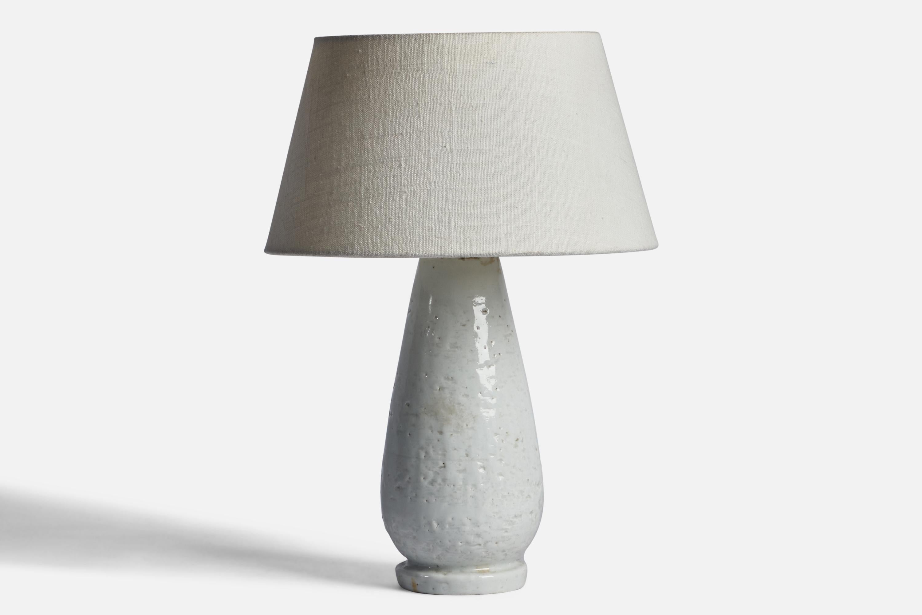 An off-white glazed stoneware table lamp designed by Gunnar Nylund and produced by Rörstrand, Sweden, 1940s.

Dimensions of Lamp (inches): 11.2” H x 4.25” Diameter
Dimensions of Shade (inches): 7” Top Diameter x 10” Bottom Diameter x 5.5” H