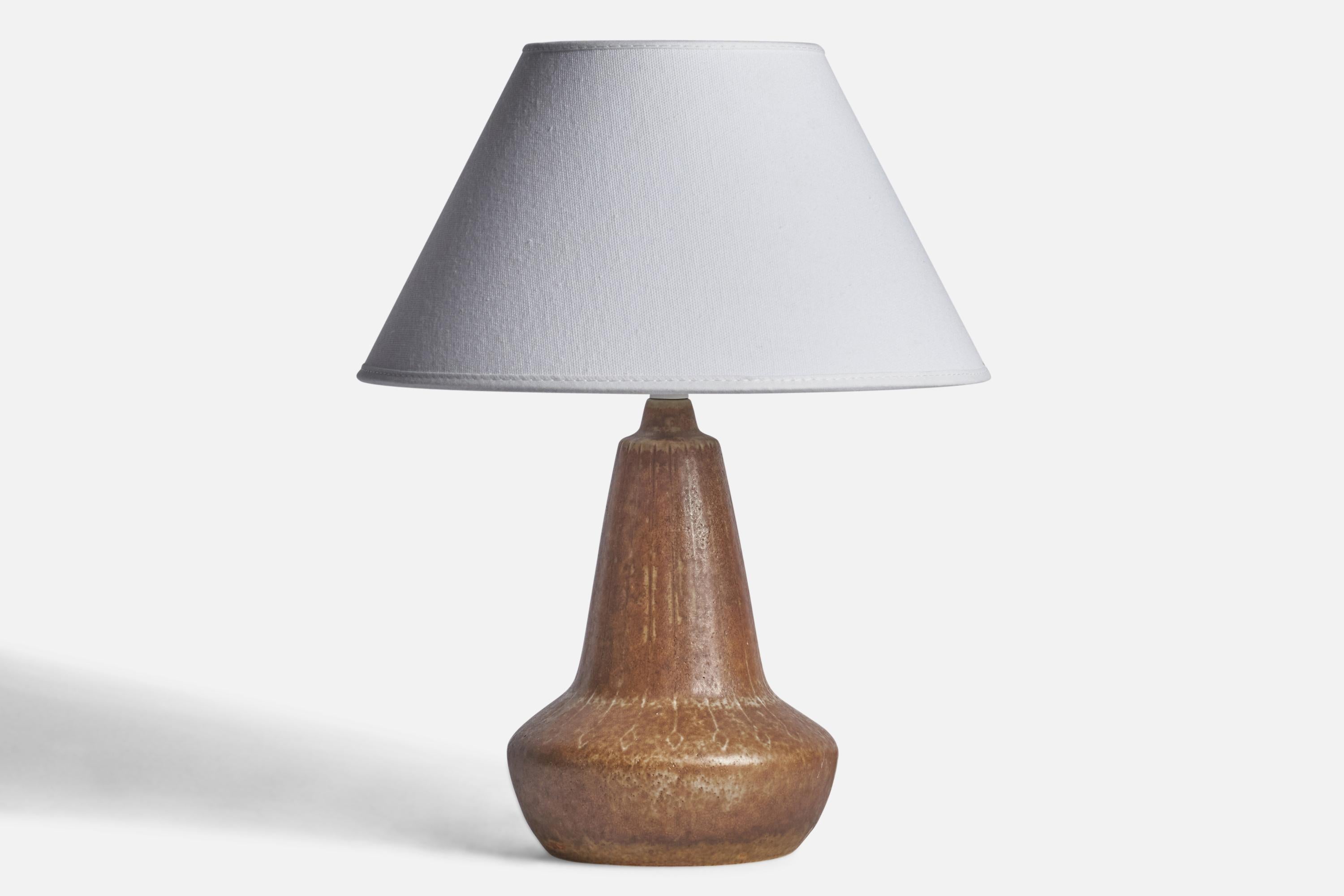 A small brown-glazed stoneware table lamp designed by Gunnar Nylund and produced by Rörstrand, Sweden, 1940s.

Dimensions of Lamp (inches): 9.5” H x 5” Diameter
Dimensions of Shade (inches): 4.25” Top Diameter x 9.75” Bottom Diameter x 5.75”