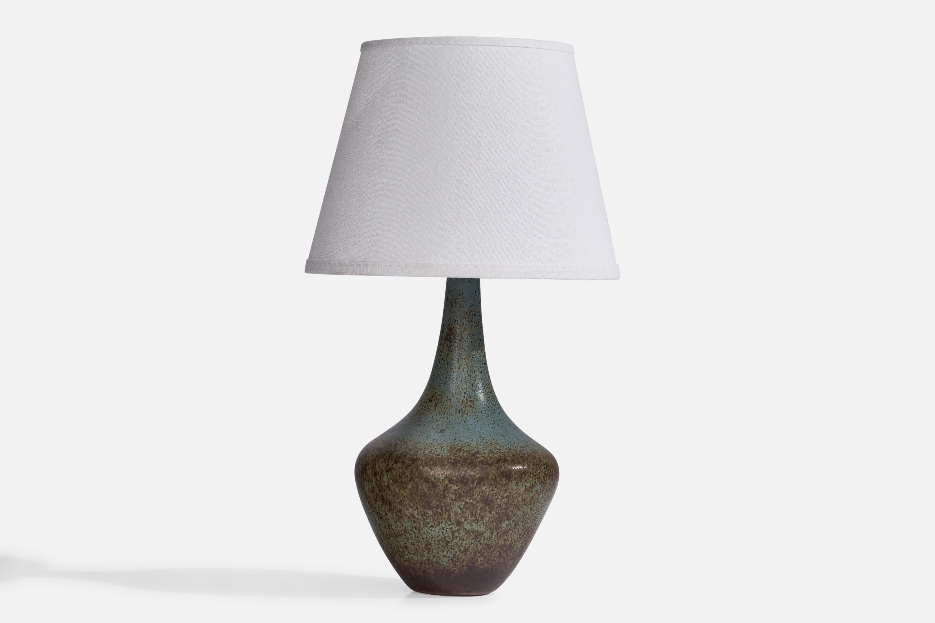 A blue and brown-glazed stoneware table lamp designed by Gunnar Nylund and produced by Rörstrand, Sweden, 1940s.

Dimensions of Lamp (inches): 11.3” H x 5” Diameter
Dimensions of Shade (inches): 5.25” Top Diameter x 8” Bottom Diameter x 6”