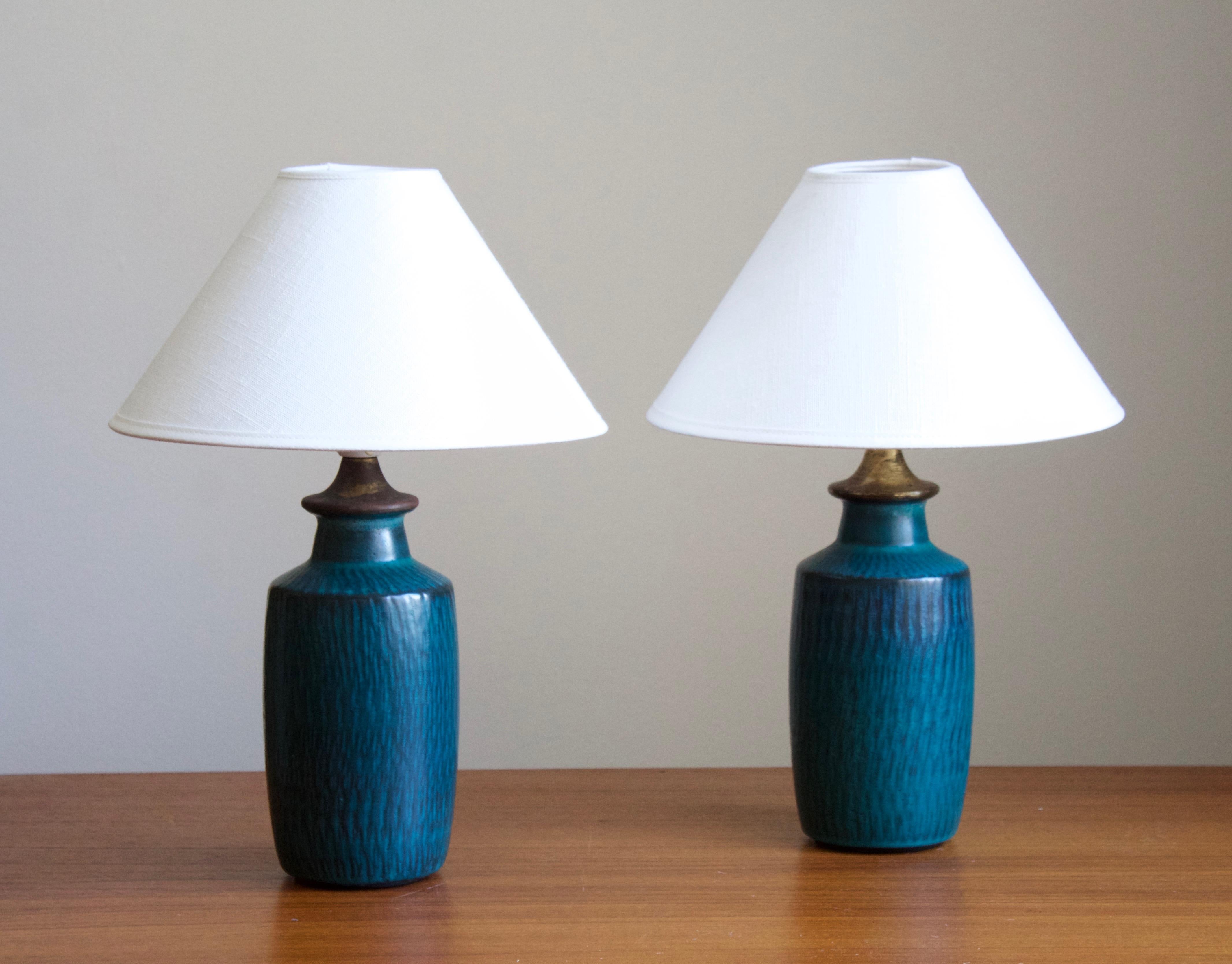 A pair of rare table lamps produced by Nymølle, Denmark, c. 1960s. Designed by Gunnar Nylund, (Swedish, 1914-1997). Signed.

Nylund served as artistic director at Rörstrands, where he worked 1931-1955. Prior to his work at Rörstrand he was a