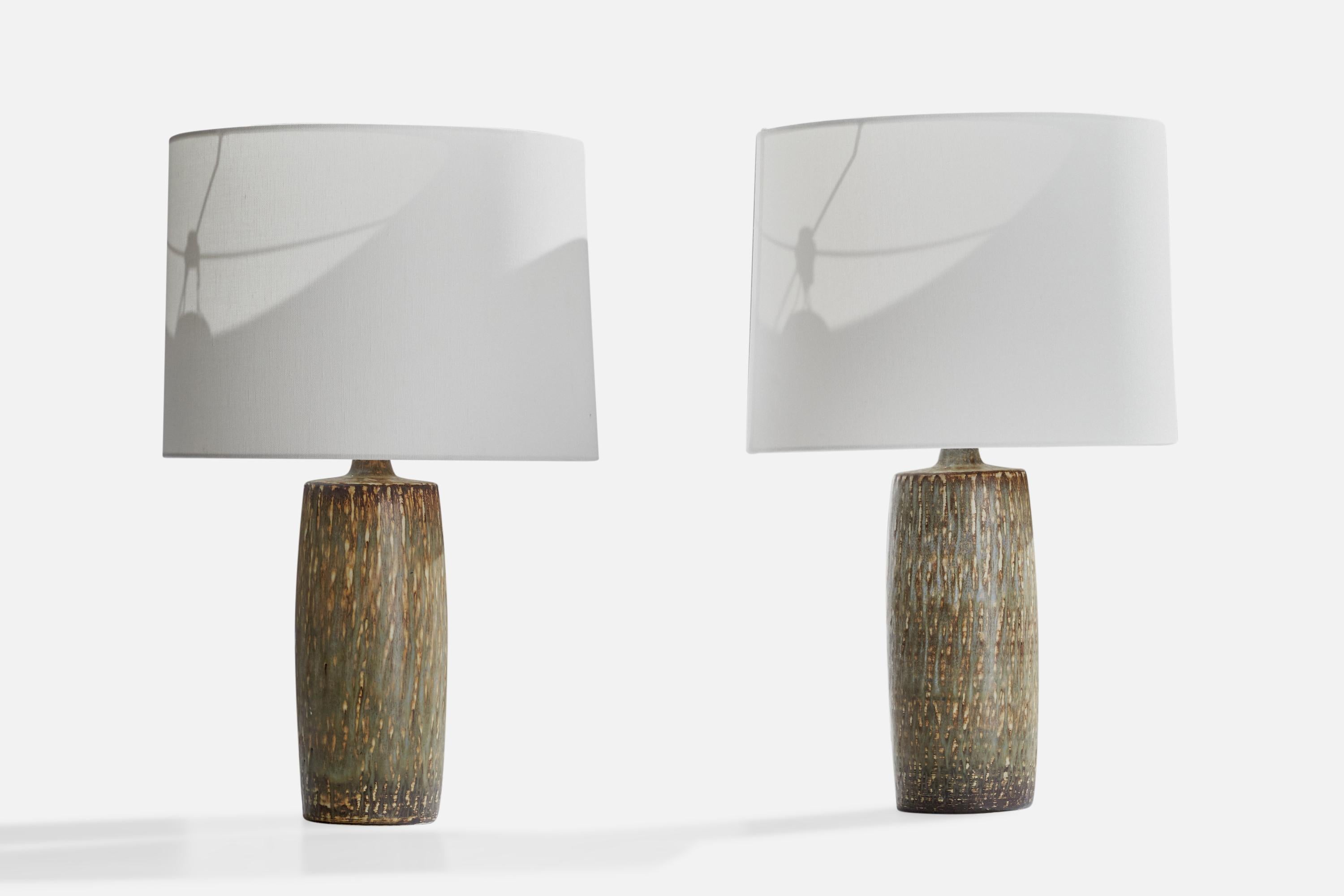 A pair of green, grey and brown-glazed stoneware table lamps designed by Gunnar Nylund and produced by Rörstrand, Sweden, 1940s.

Dimensions of Lamp (inches): 15.5”  H x 5” Diameter
Dimensions of Shade (inches): 13” Top Diameter x 14