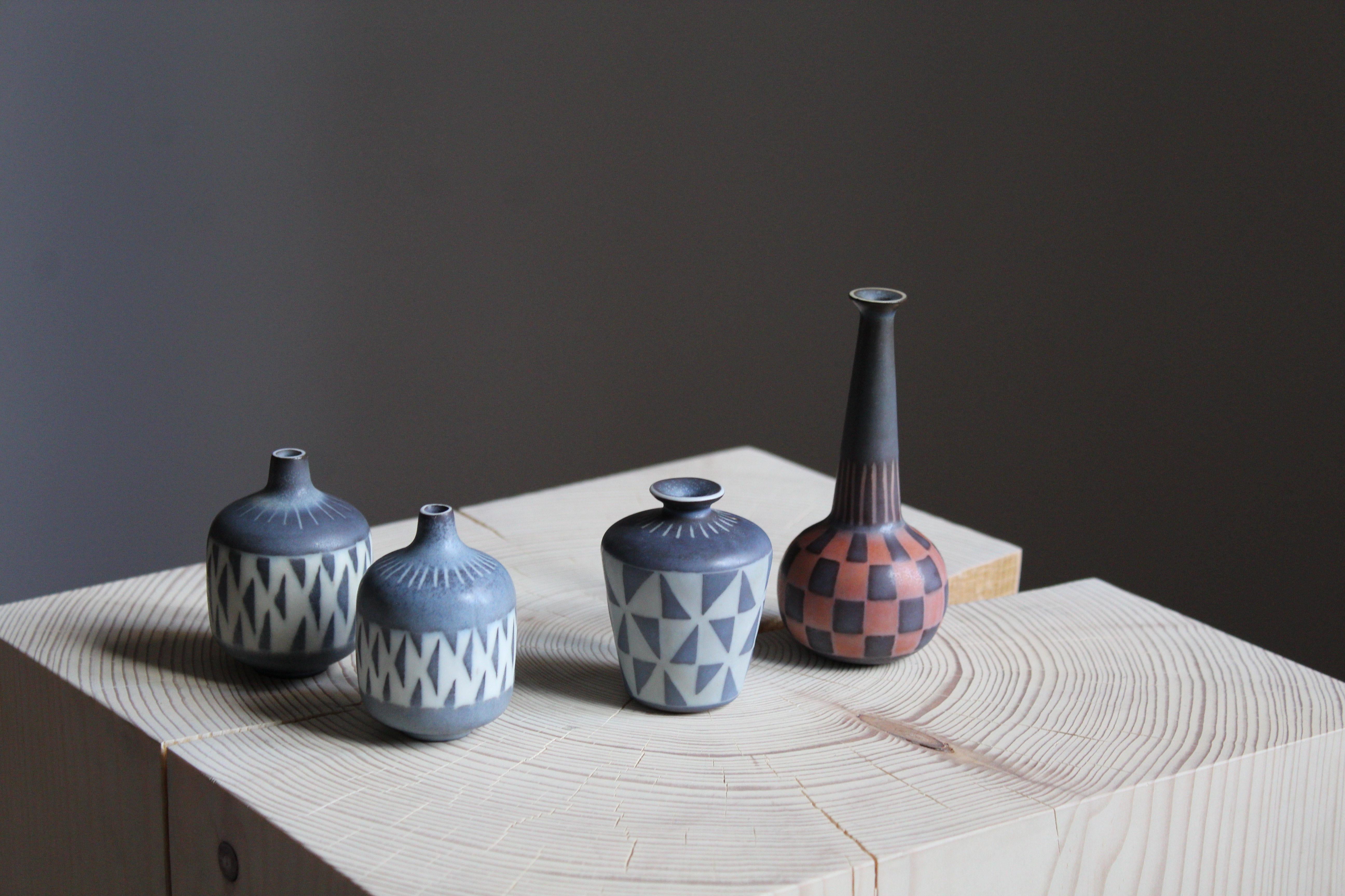 A collection of 4 small vases in stoneware and produced by Rörstrands, Sweden, 1940s. Designed and signed by Gunnar Nylund, (Swedish 1914-1997). All vases with highly artistic hand painted patterns.

Nylund served as artistic director at