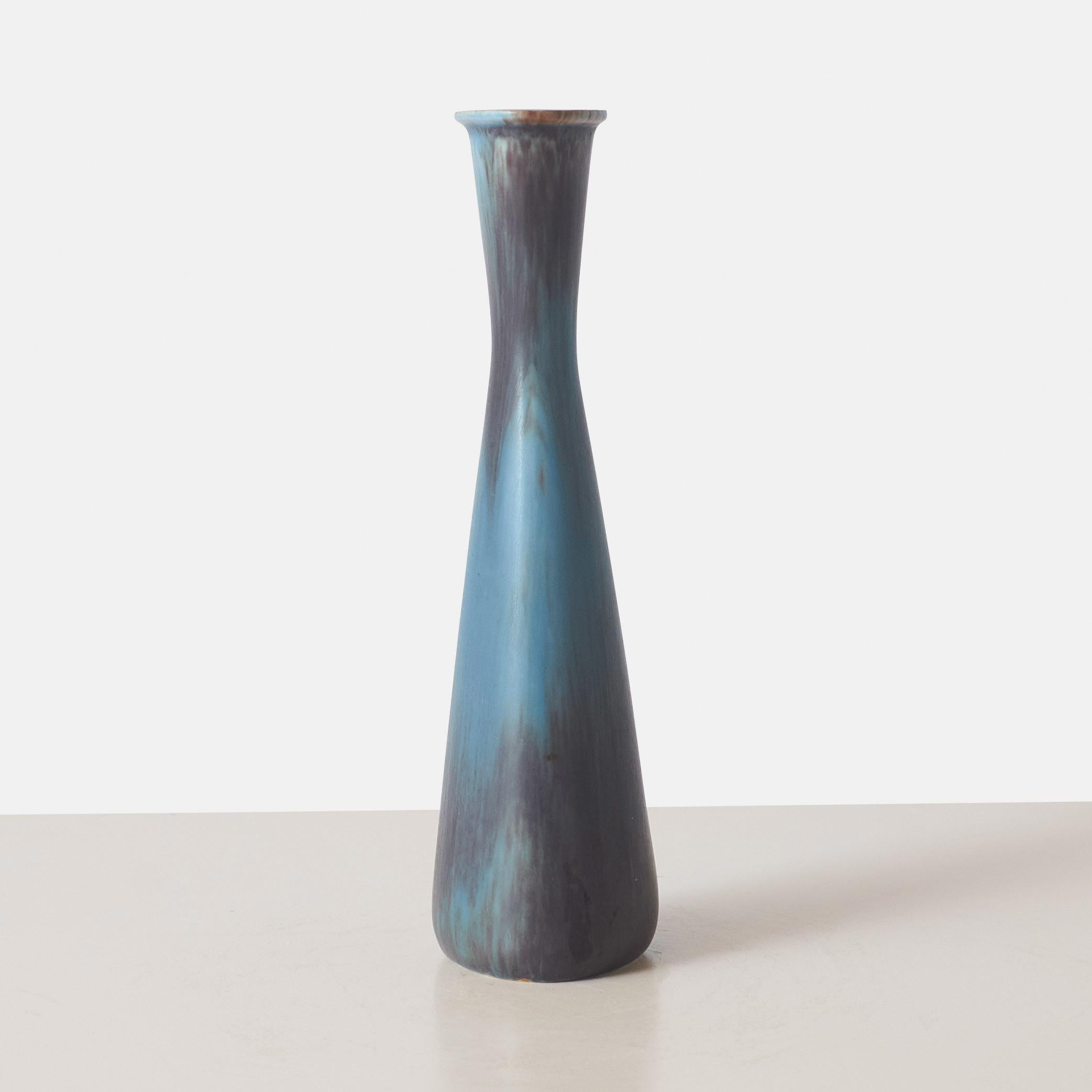 A narrow stoneware blue vase by Gunnar Nylund for Rörstrand with ovoid shaped opening to neck.