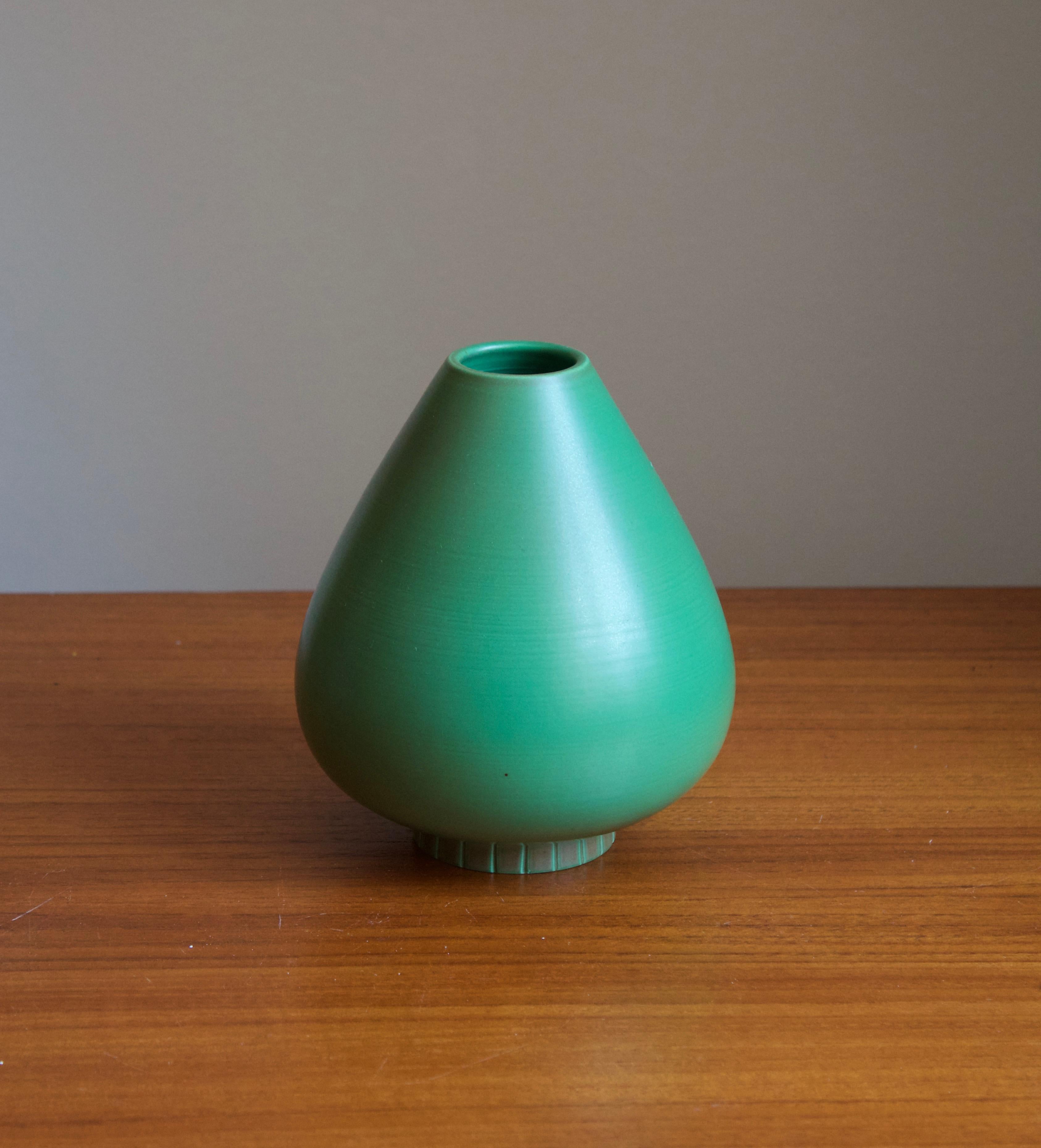 A vase or vessel produced by Rörstrands, Sweden, 1950s. Designed by Gunnar Nylund, (Swedish, 1914-1997). Signed.

Nylund served as artistic director at Rörstrands, where he worked 1931-1955. Prior to his work at Rörstrand he was a well-established