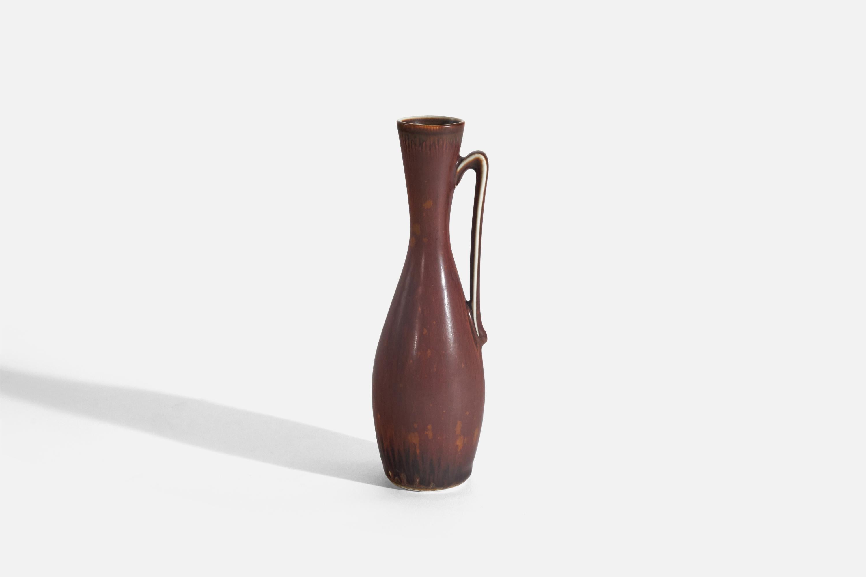 A red-glazed stoneware vase, 