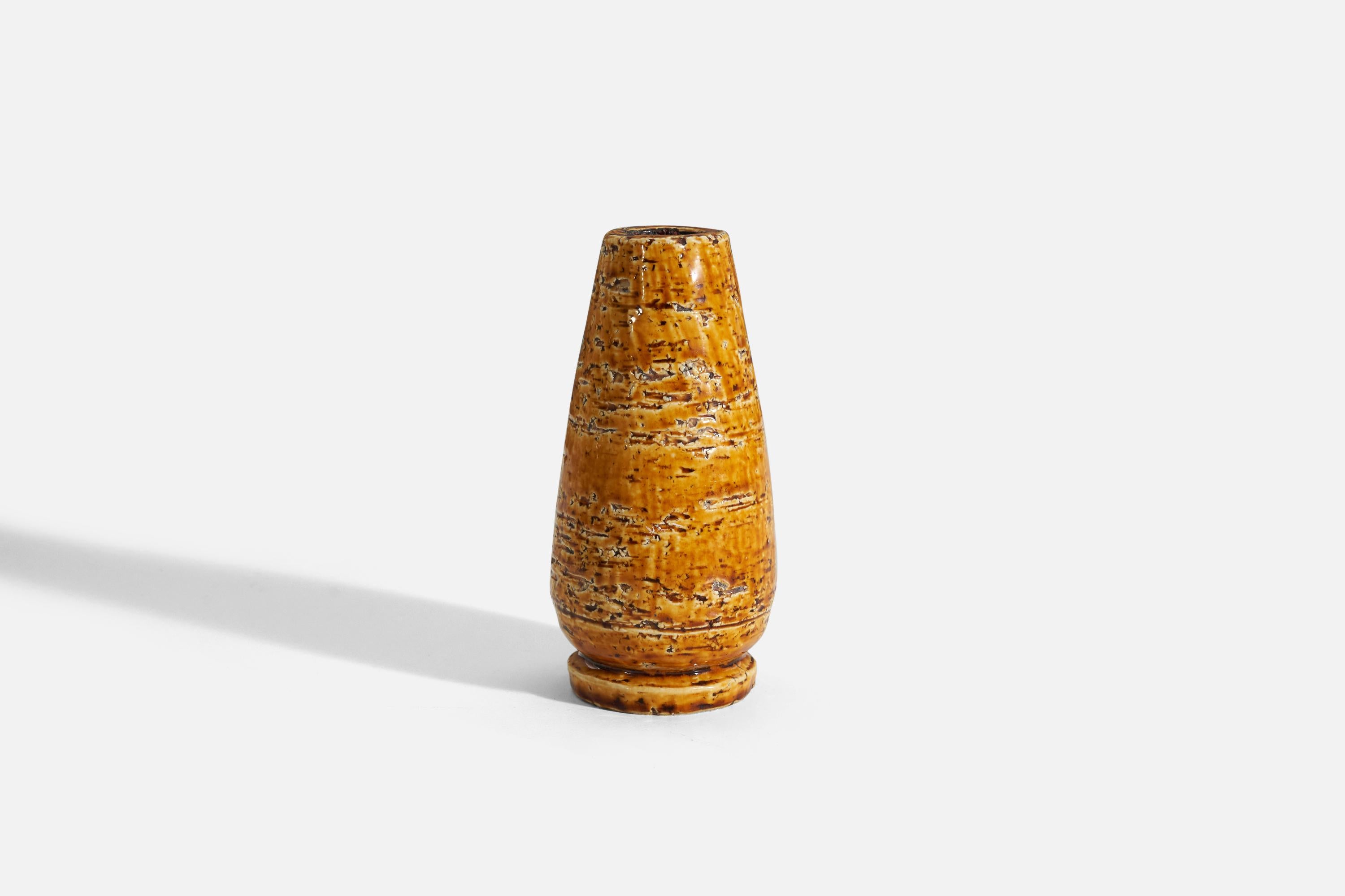 An orange glazed vase designed by Gunnar Nylund (Swedish, 1914-1997) and produced by Rörstrand, Sweden, 1940s. 

Nylund served as artistic director at Rörstrand, where he worked 1931-1955. Prior to his work at Rörstrand he was a well-established